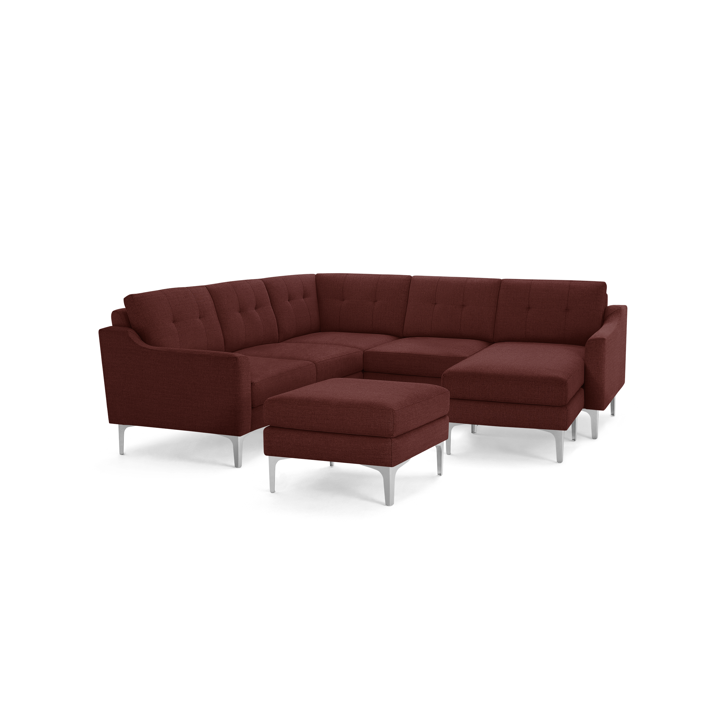 Modern L-shaped sectional sofa in deep red fabric with tufted cushions, featuring slim metallic legs and a matching ottoman.