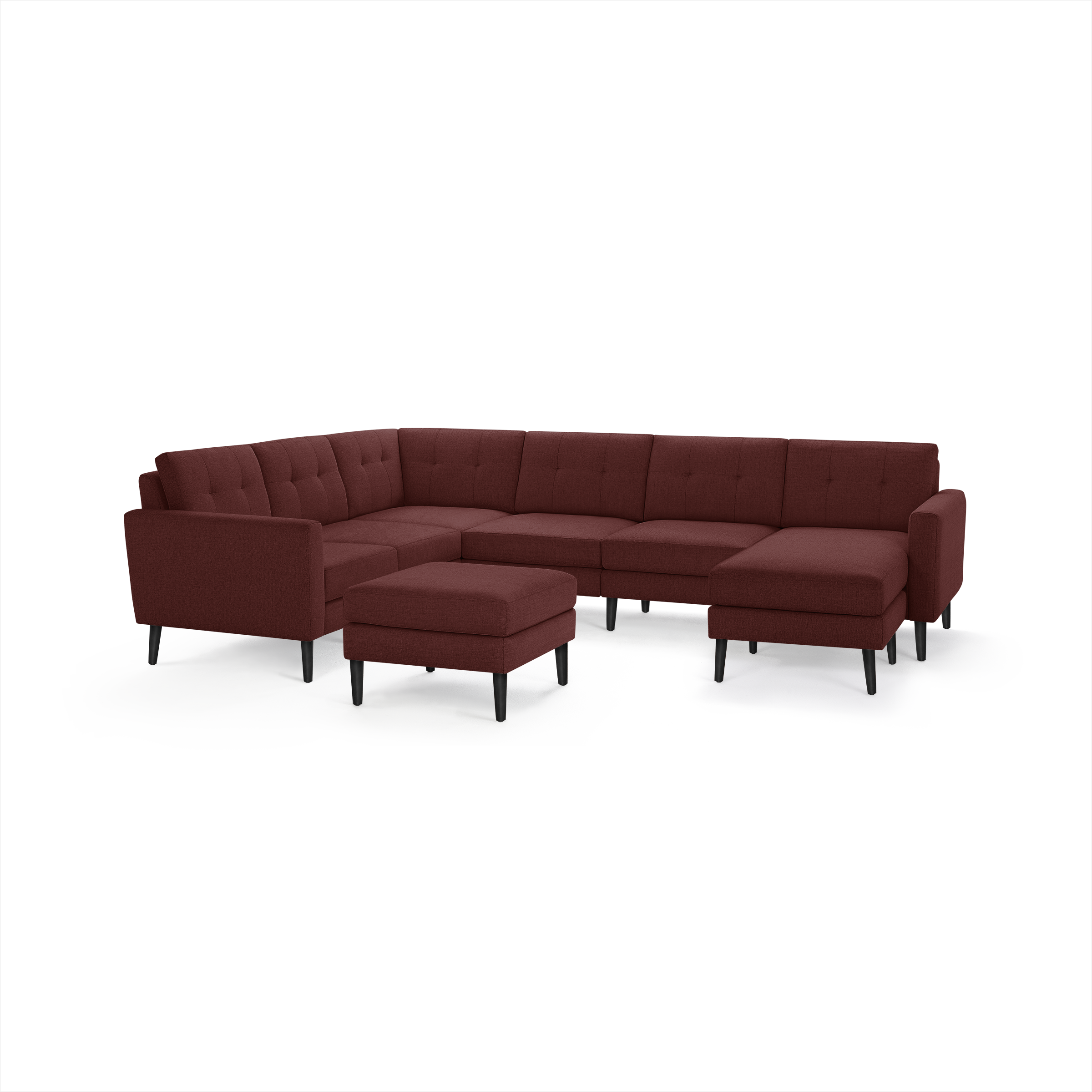 Large modern sectional sofa in deep red fabric with tufted back cushions and matching ottoman, supported by black tapered legs.