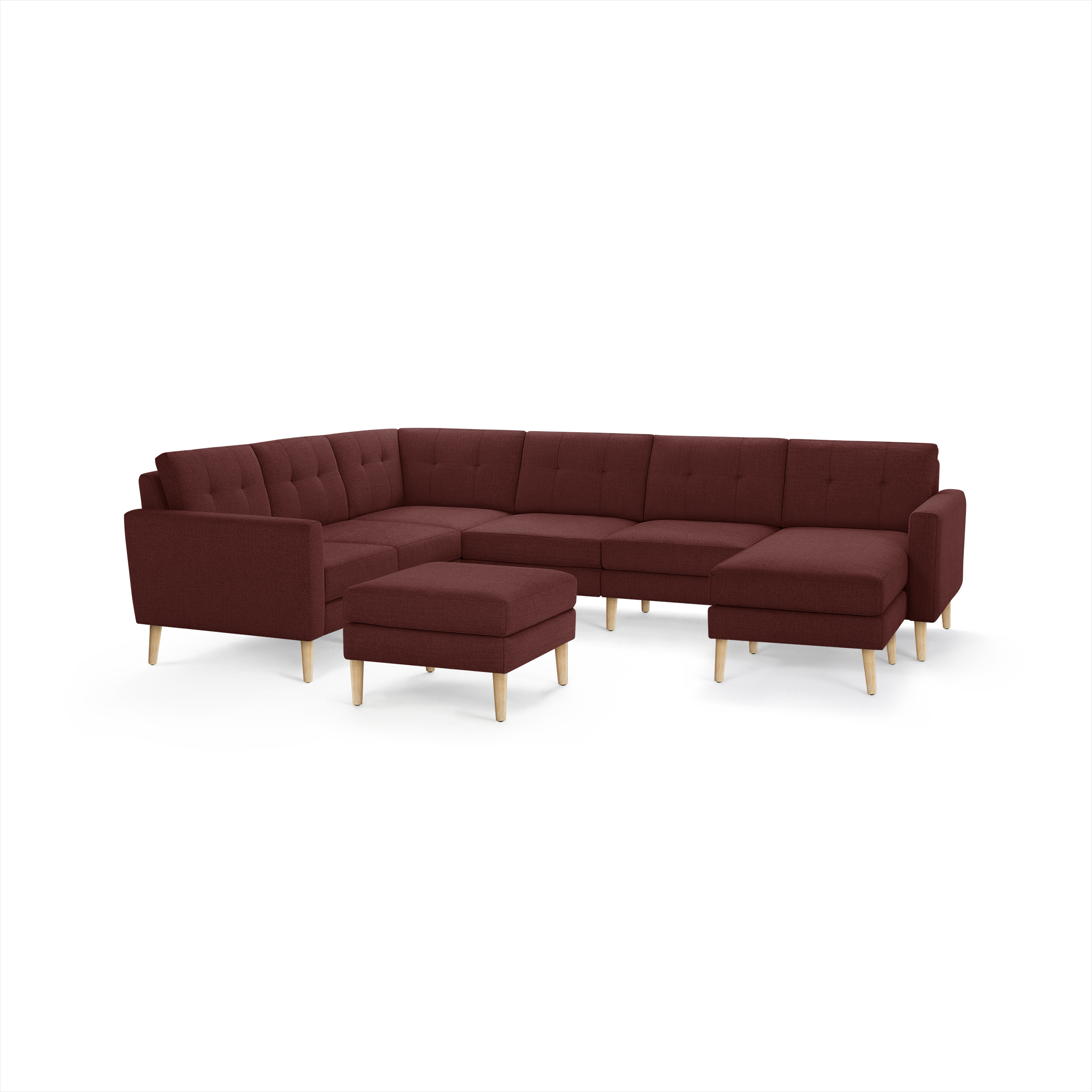 Modern burgundy fabric sectional sofa with wooden legs, tufted back cushions, and matching ottoman, designed for spacious living rooms.