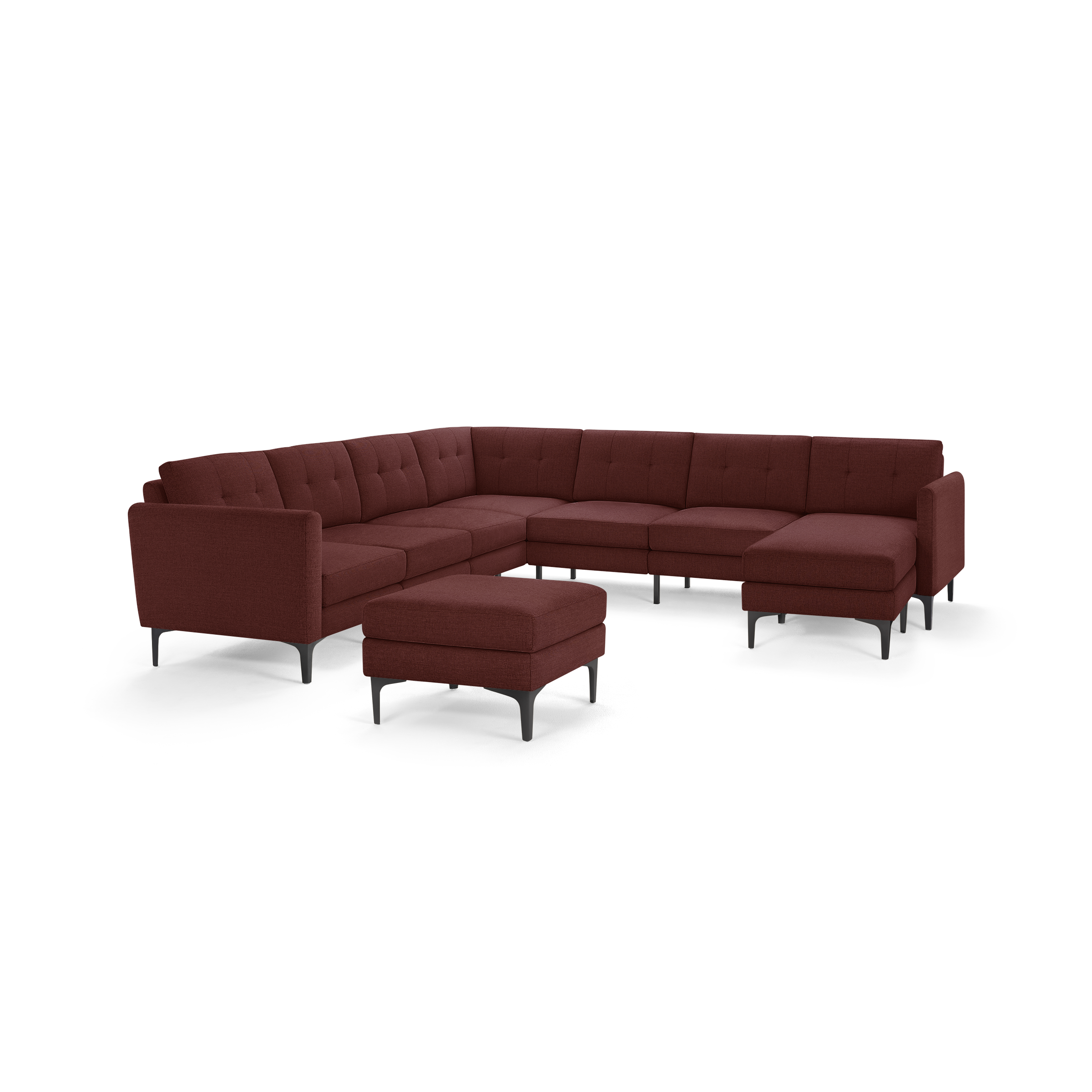 Modern L-shaped sectional sofa in deep red fabric with tufted back cushions and matching ottoman, supported by black metal legs.