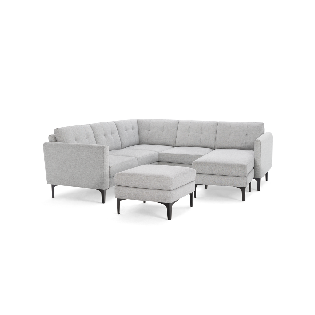 Light gray fabric sectional sofa with tufted backrest, metal legs, and matching ottoman. Modern and minimalist design.