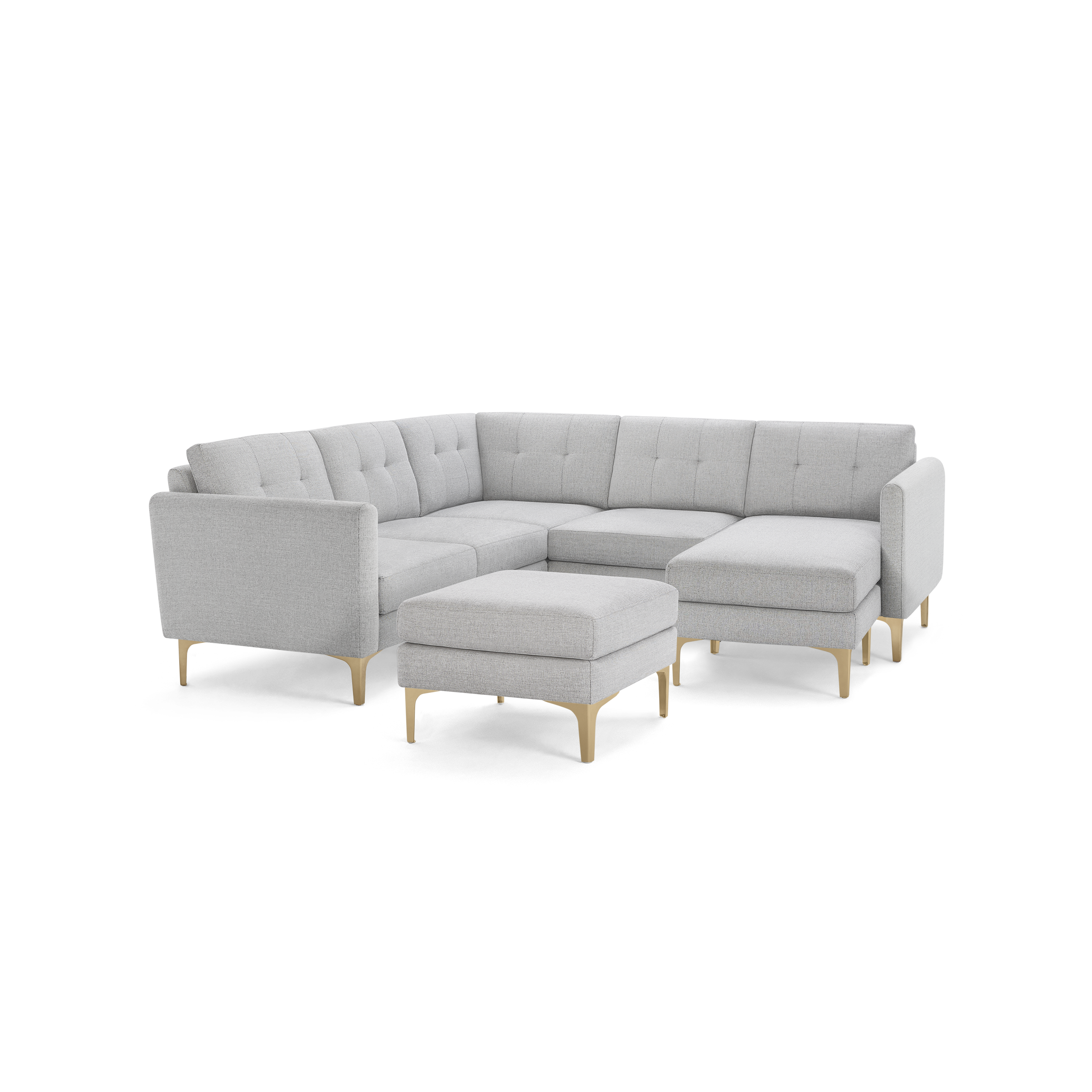 Light gray fabric upholstered modern sectional sofa with wooden legs and matching ottoman, featuring tufted back cushions.