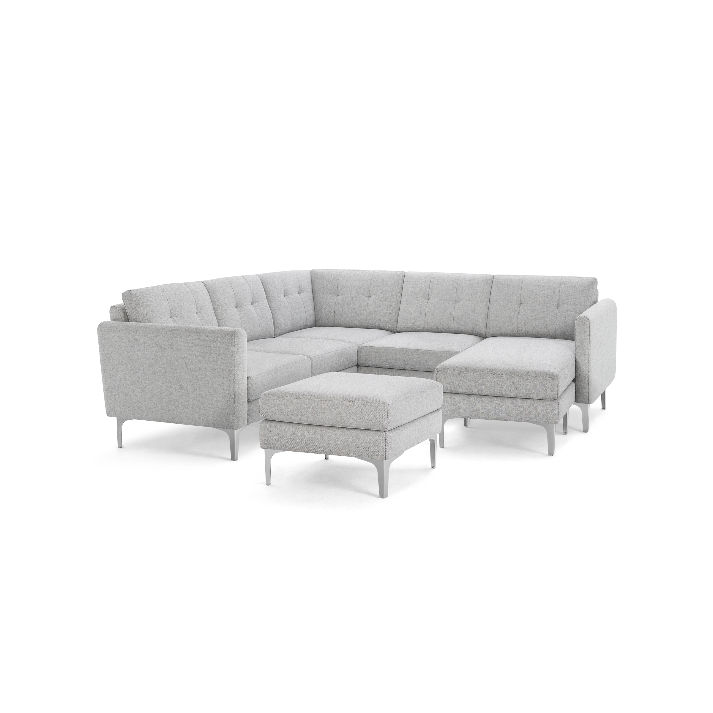 Light gray modern sectional sofa with tufted cushions, metal legs, and matching ottoman against black background.
