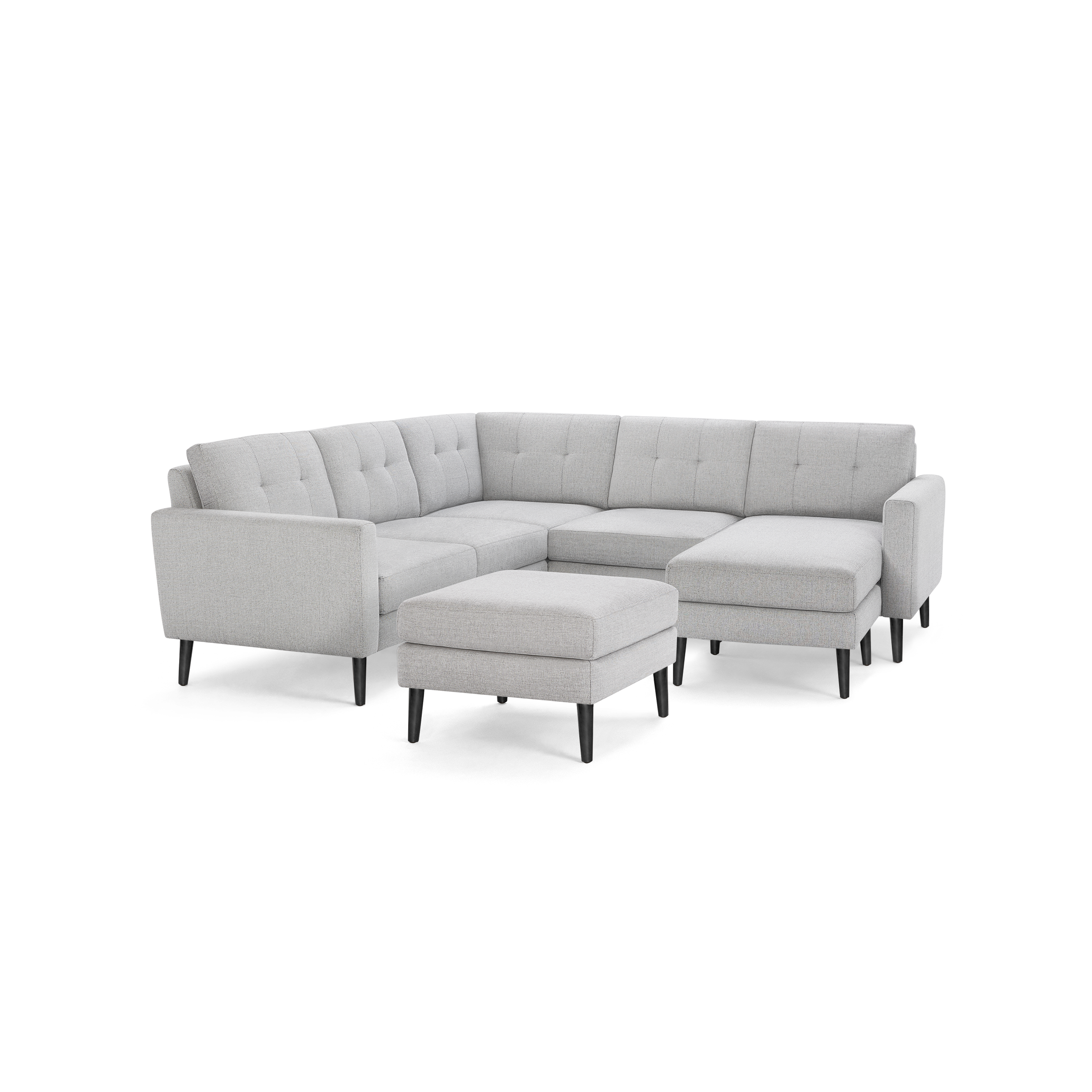 Light gray fabric sectional sofa with tufted back cushions, black tapered legs, and matching ottoman. Modern, minimalist design with clean lines.