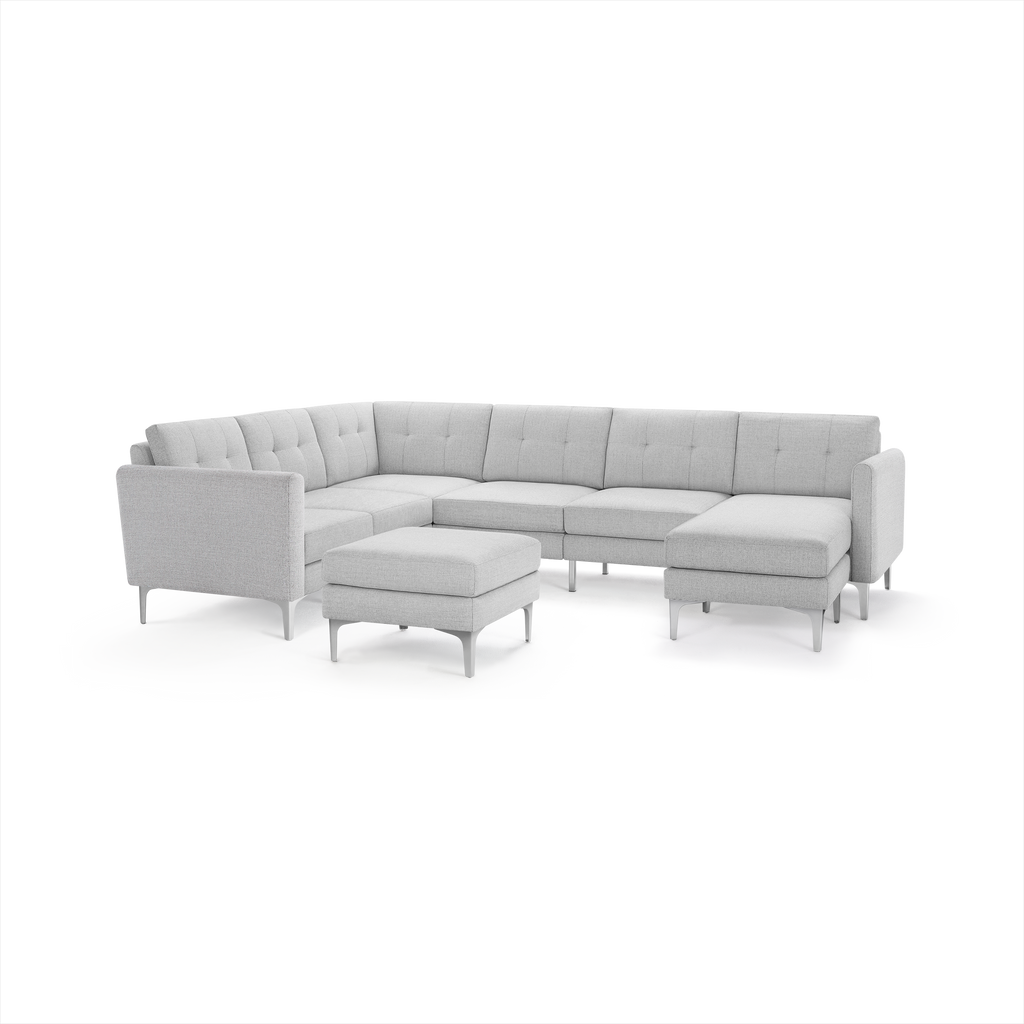 Light gray modern L-shaped sectional sofa with tufted cushions, metal legs, and a matching square ottoman.