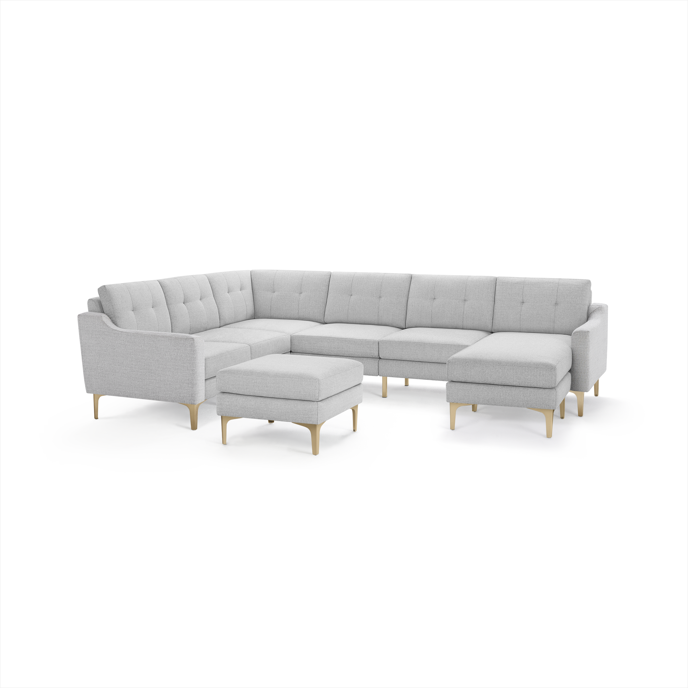 Light gray upholstered L-shaped sectional sofa with tufted back cushions, wooden legs, and a matching upholstered ottoman.