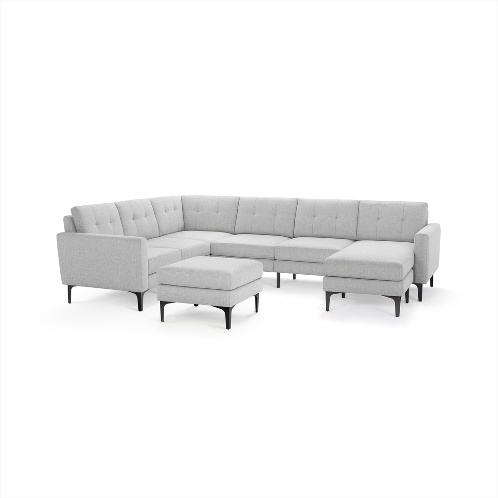 Light gray modern sectional sofa with tufted cushions, metal legs, and a matching square ottoman on a white background.