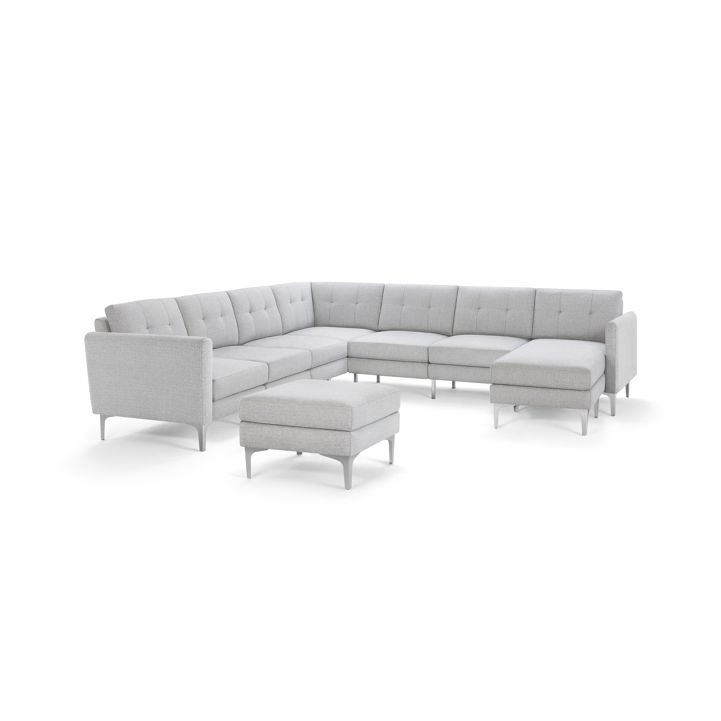 Light gray modern sectional sofa with tufted cushions and slim metal legs, accompanied by a matching ottoman.