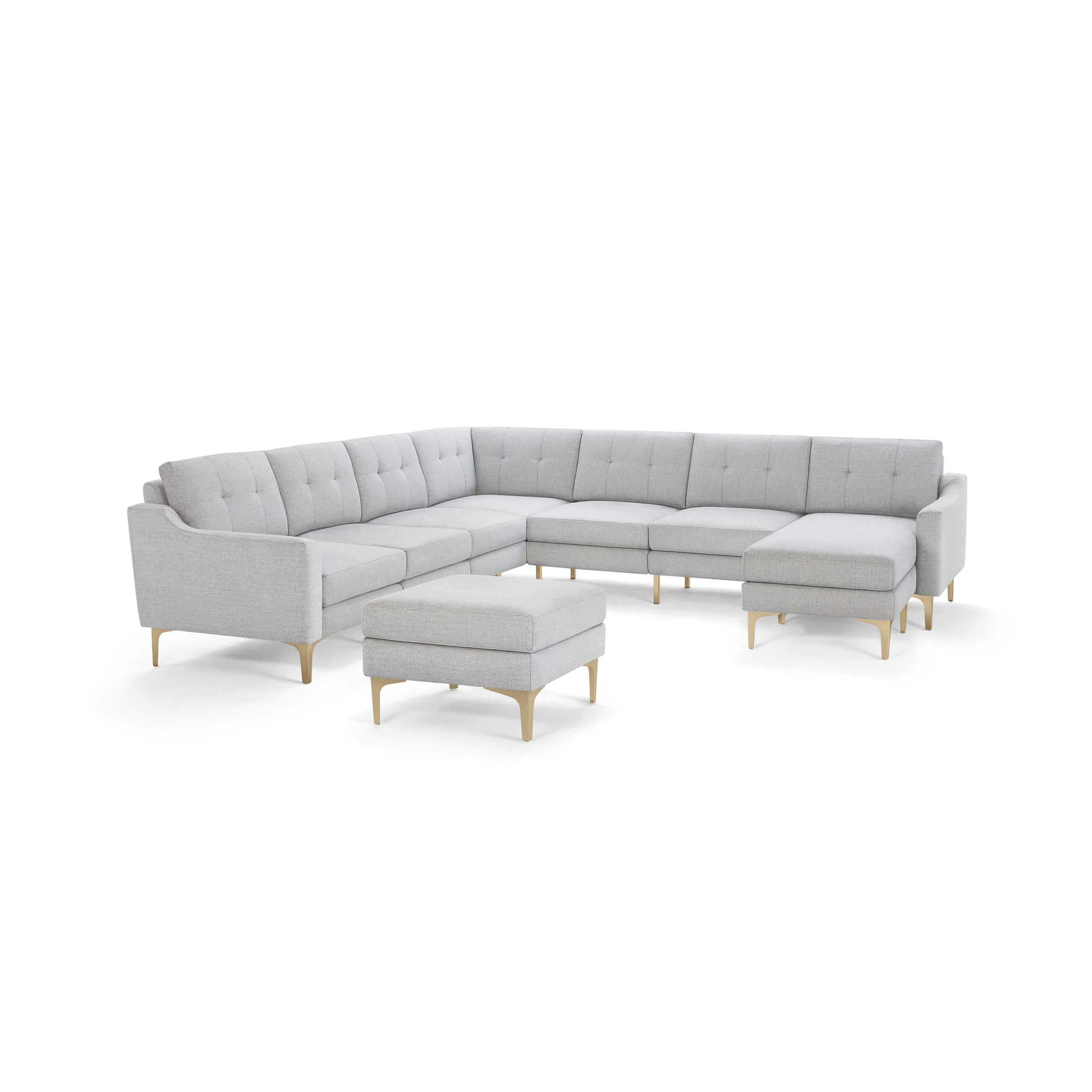 Light gray fabric sectional sofa with tufted back cushions and wooden legs, featuring a matching ottoman.