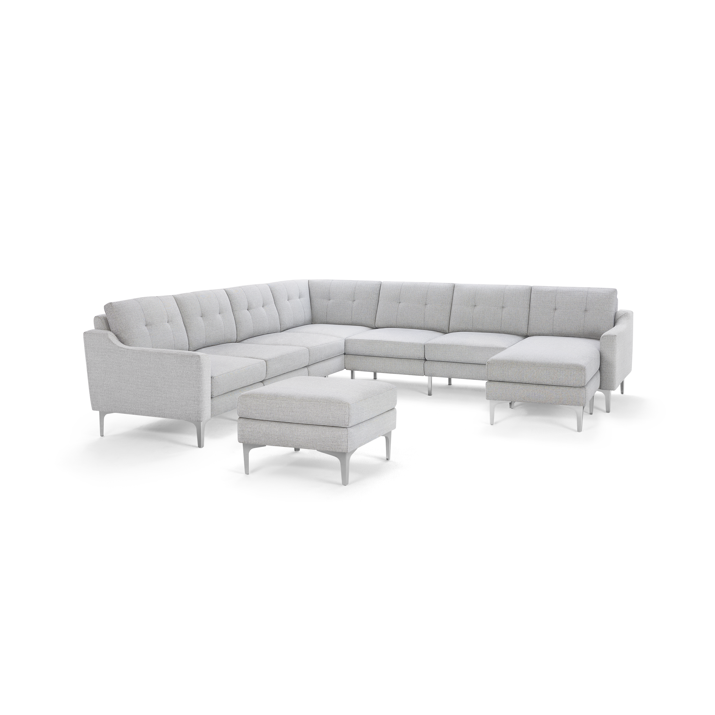 Light gray L-shaped sectional sofa with tufted cushions and matching ottoman, supported by sleek metal legs.