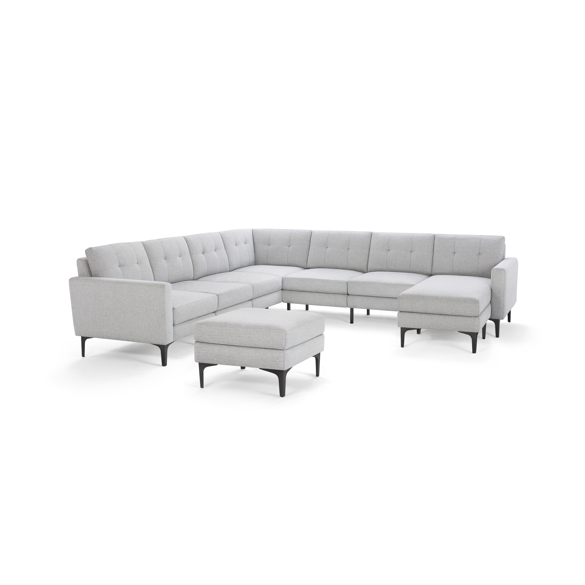 Light gray L-shaped sectional sofa with tufted back cushions and black metal legs, accompanied by a matching ottoman.