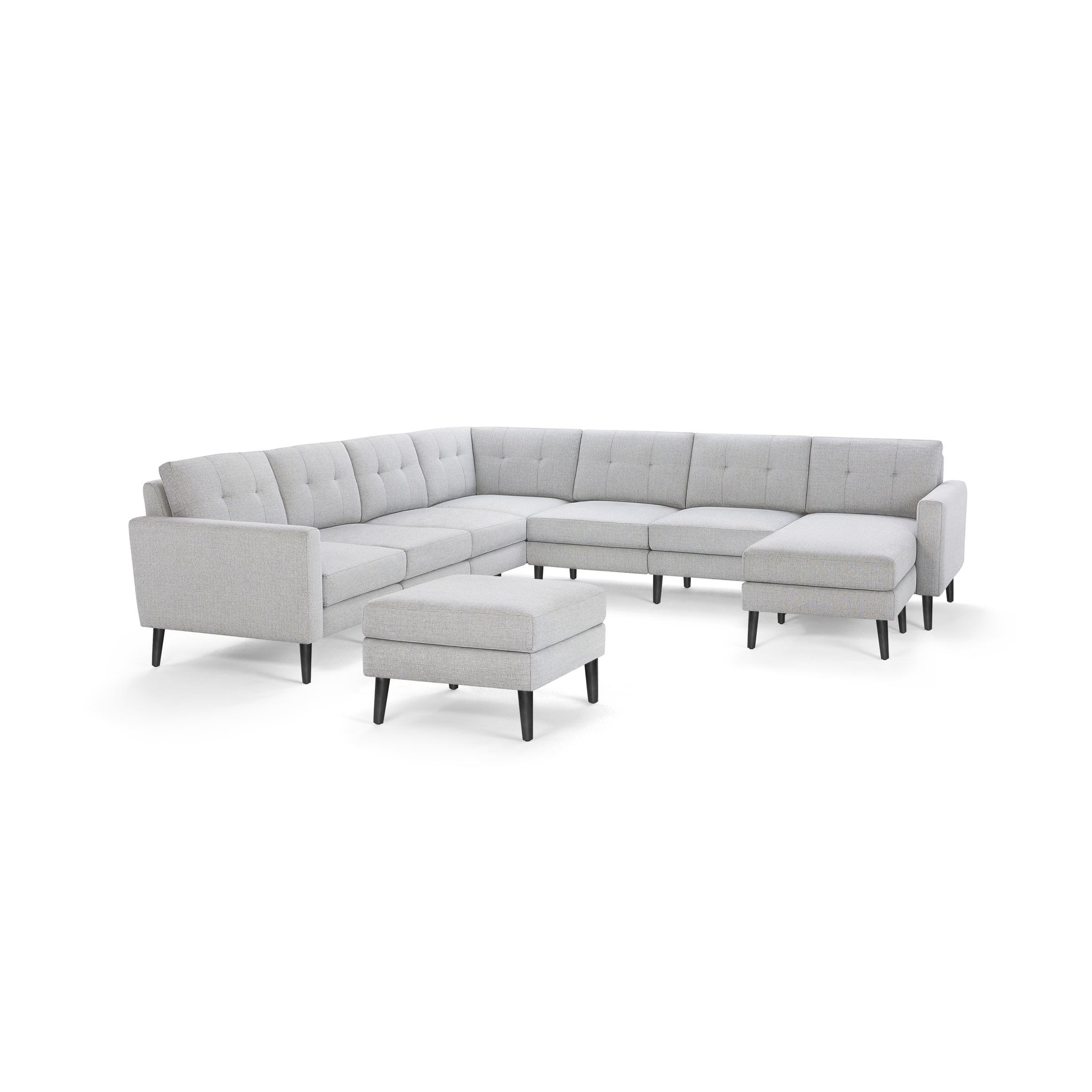 Light gray upholstered modern L-shaped sectional sofa with tufted back cushions and matching ottoman on black tapered legs.