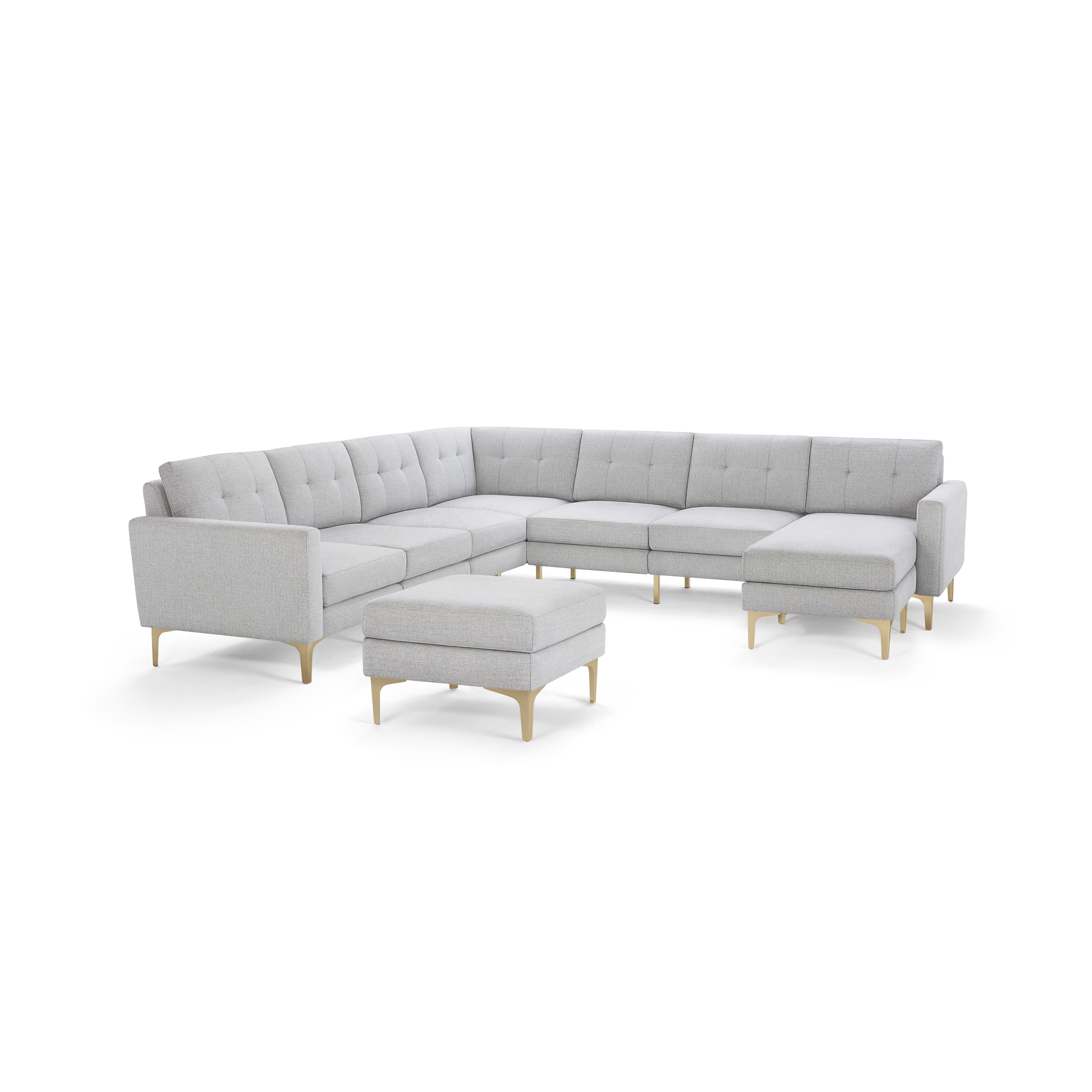 Light gray fabric sectional sofa with tufted back cushions, wooden legs, and matching ottoman on white background.