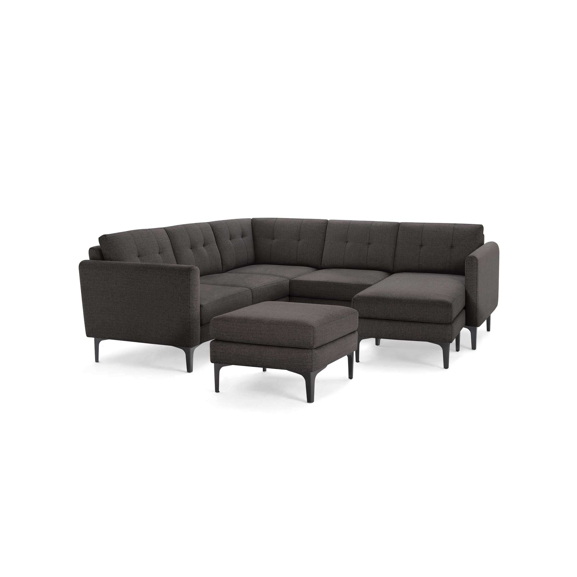 Dark gray fabric sectional sofa with tufted back cushions and matching ottoman, supported by black metal legs.