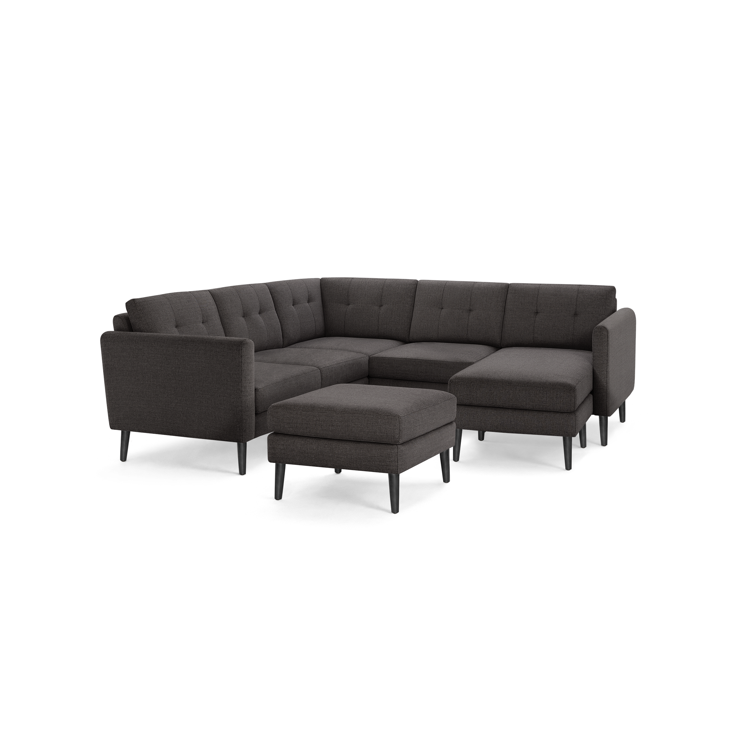 Dark gray modern L-shaped sectional sofa with tufted cushions and matching ottoman, featuring slim black legs.