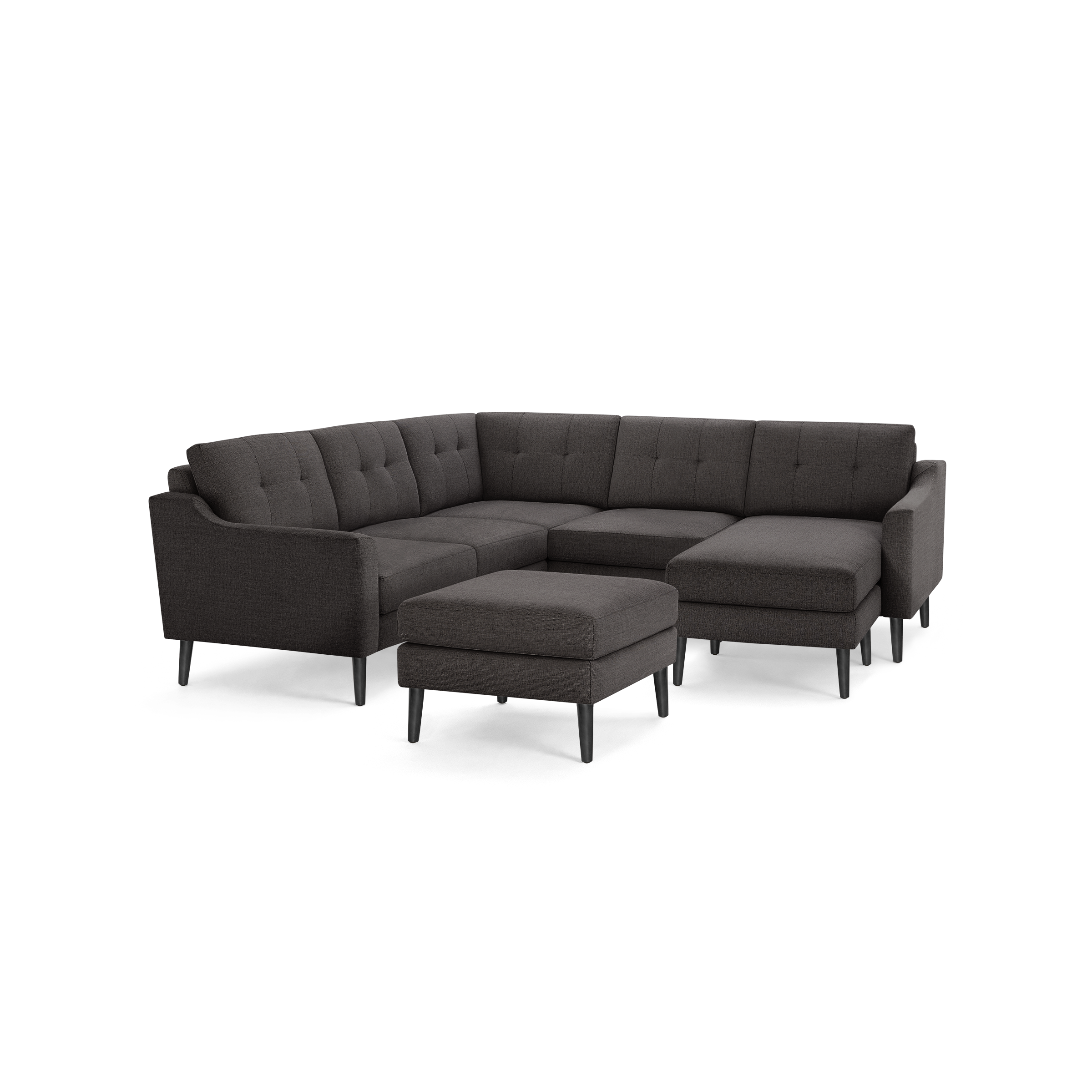 Dark gray fabric L-shaped sectional sofa with tufted back cushions and matching ottoman, supported by black tapered legs.