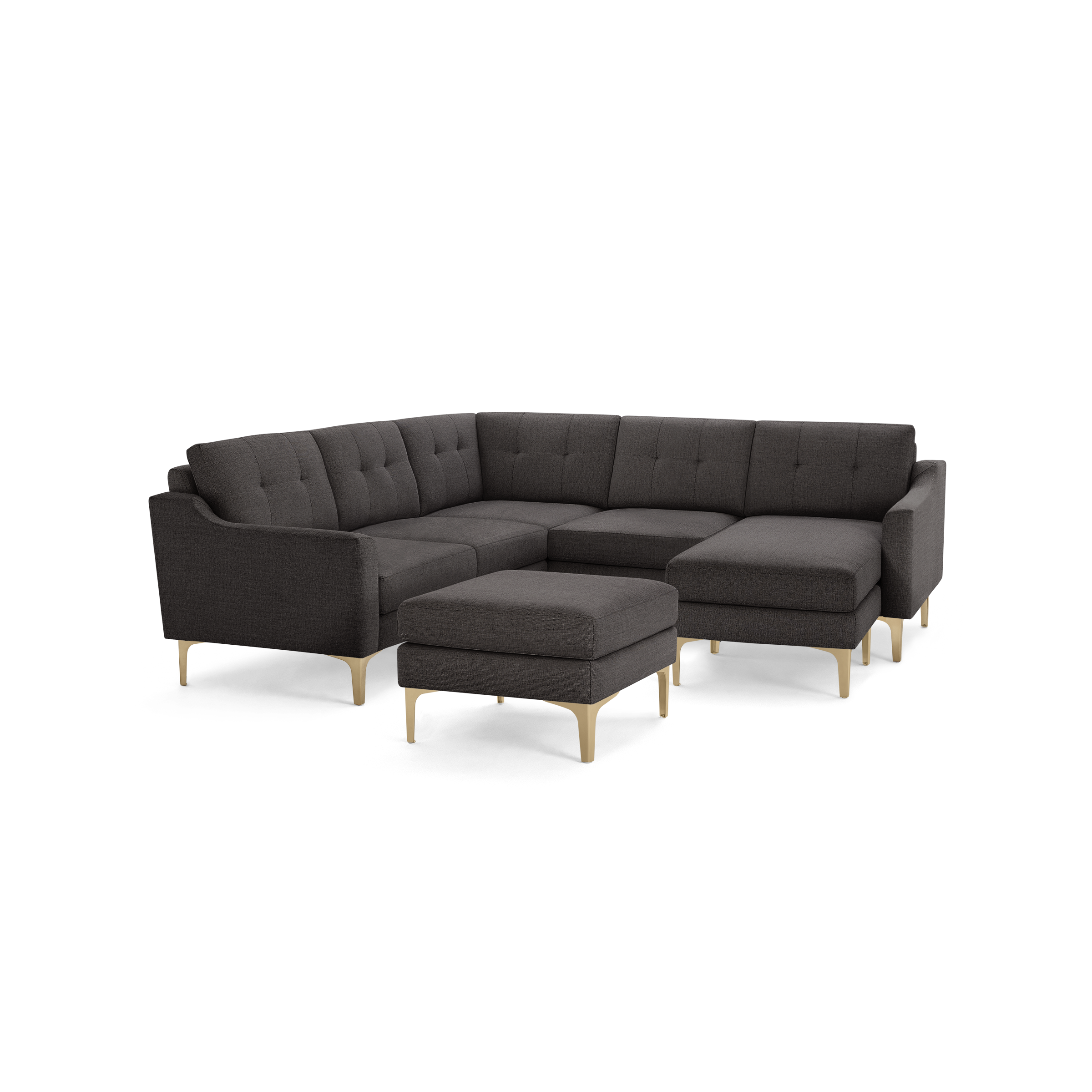 Dark gray fabric sectional sofa with tufted cushions, light wooden legs, and a matching ottoman.