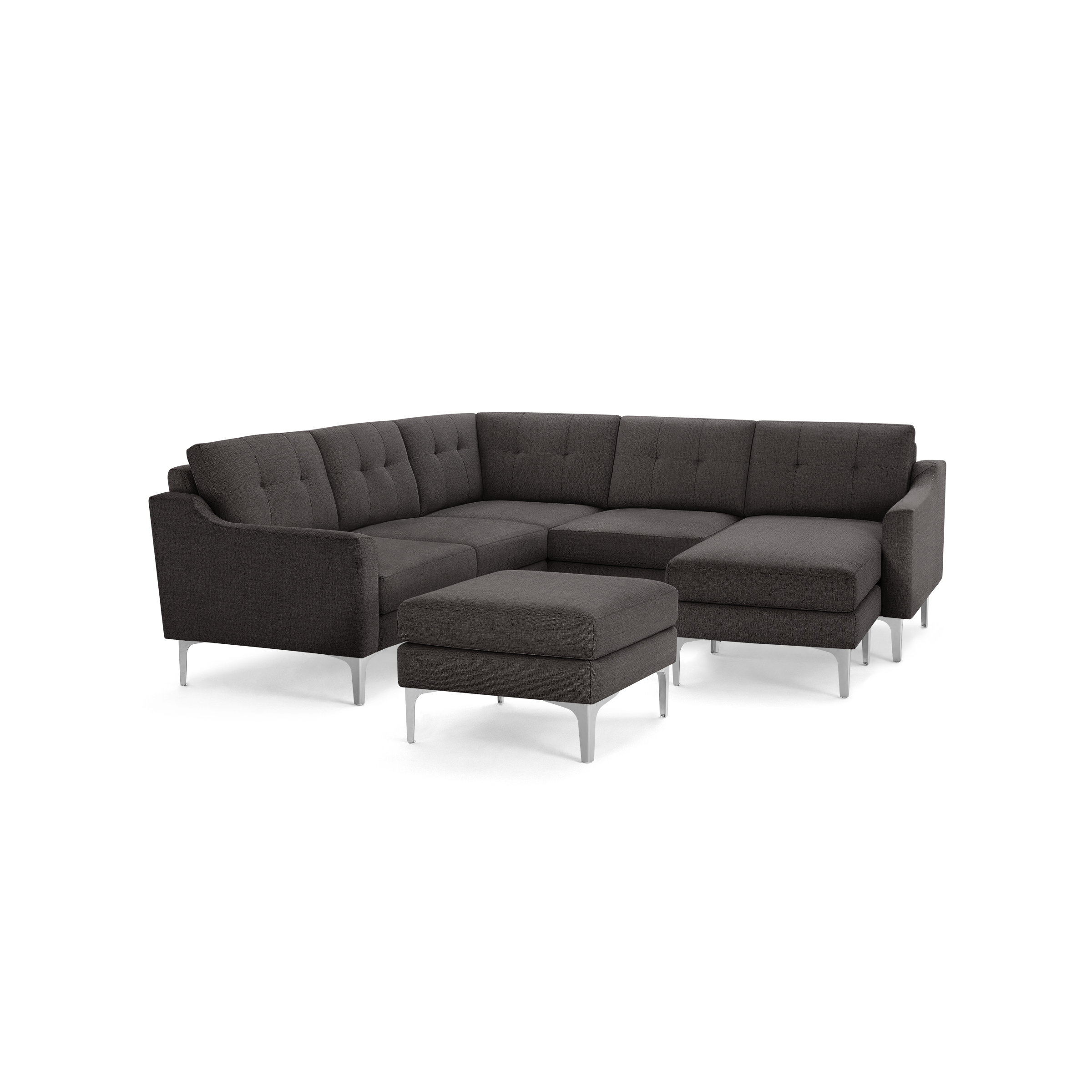 Dark gray modern sectional sofa with tufted cushions, metal legs, and a matching ottoman on black background.