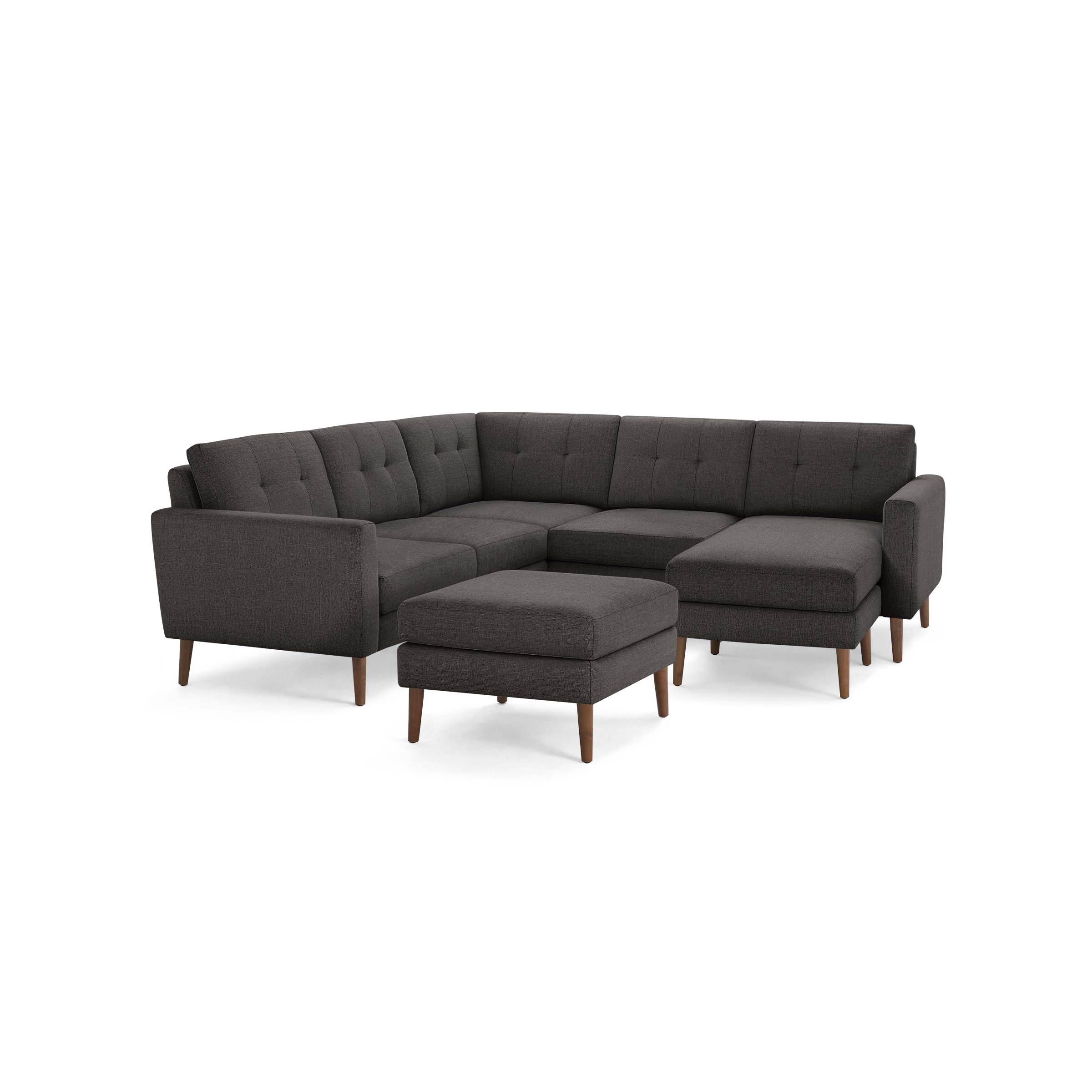 Dark gray fabric L-shaped sectional sofa with tufted cushions and wooden legs, including a matching ottoman.