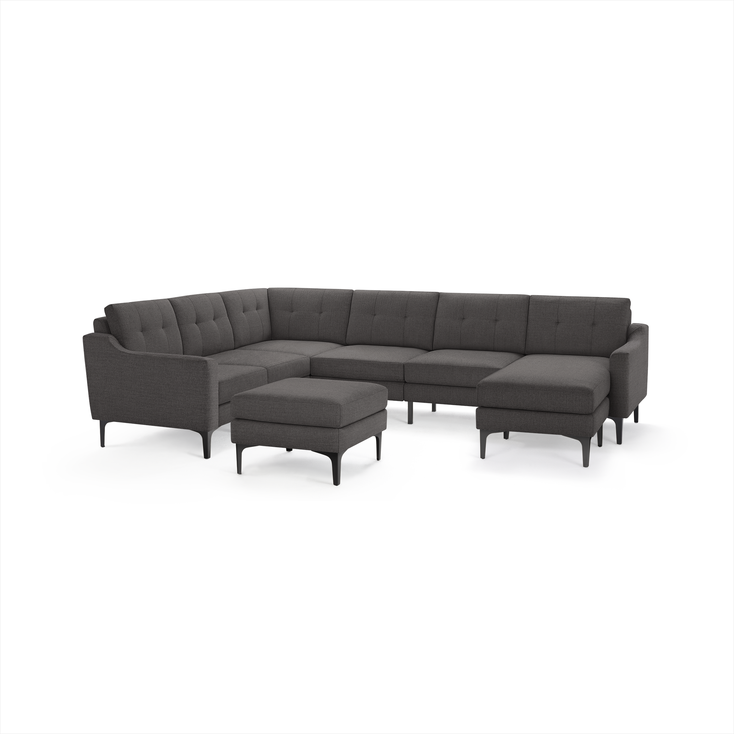 Dark gray L-shaped sectional sofa with tufted cushions, sleek armrests, metal legs, and a matching ottoman.
