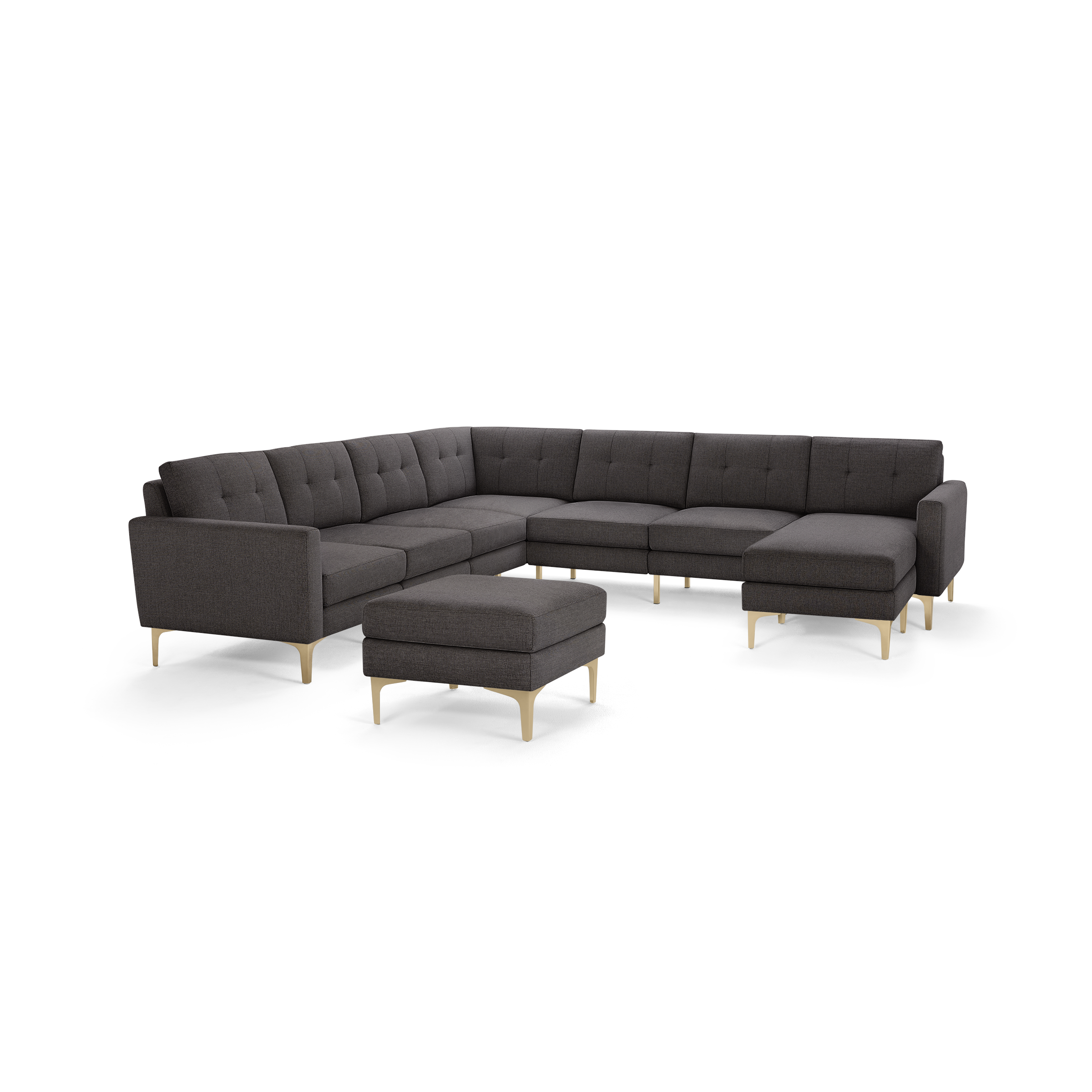 Dark gray fabric sectional sofa with tufted cushions and light wooden legs, including a matching ottoman.