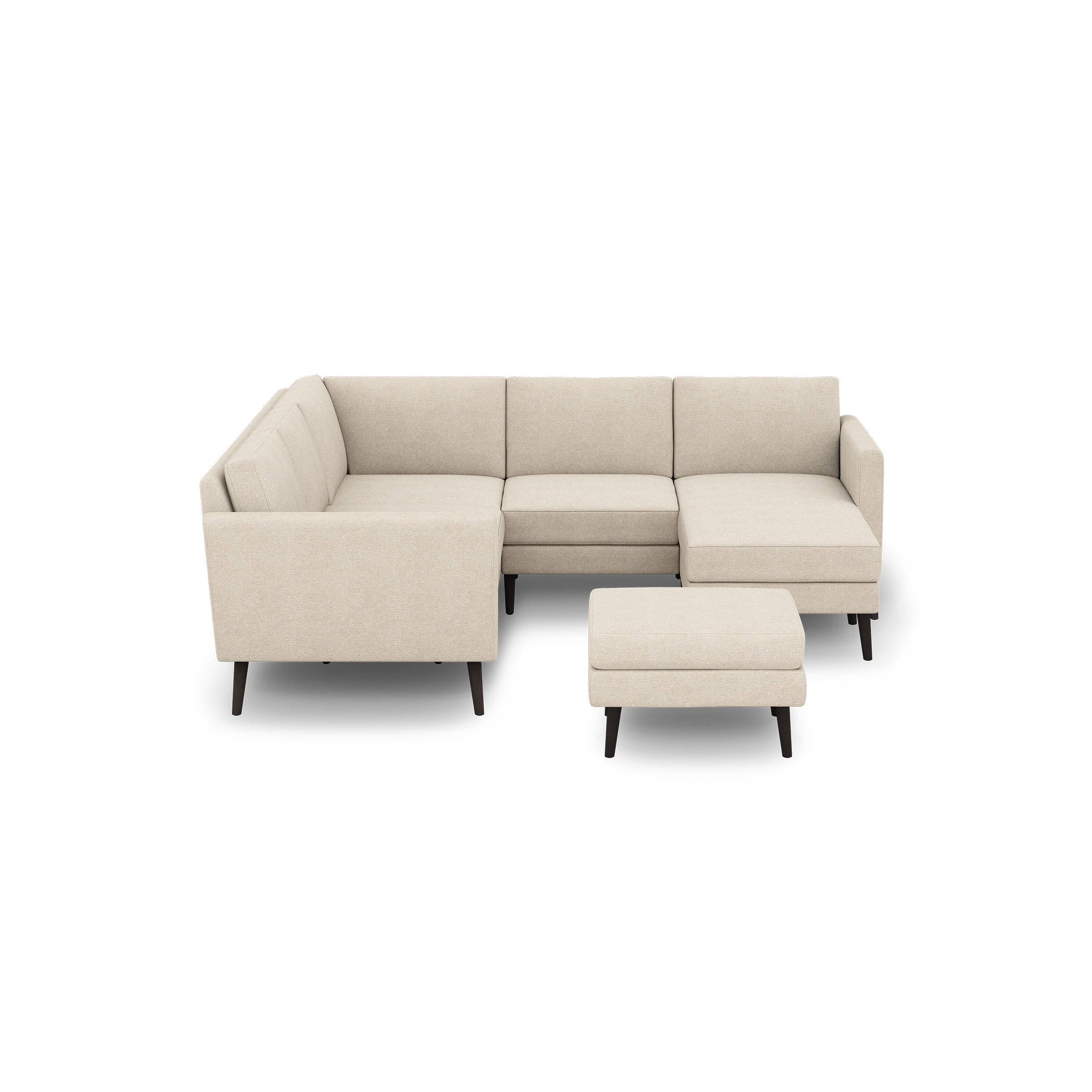 Beige L-shaped sectional sofa with tufted back cushions, matching ottoman, and dark wooden legs on a black background.