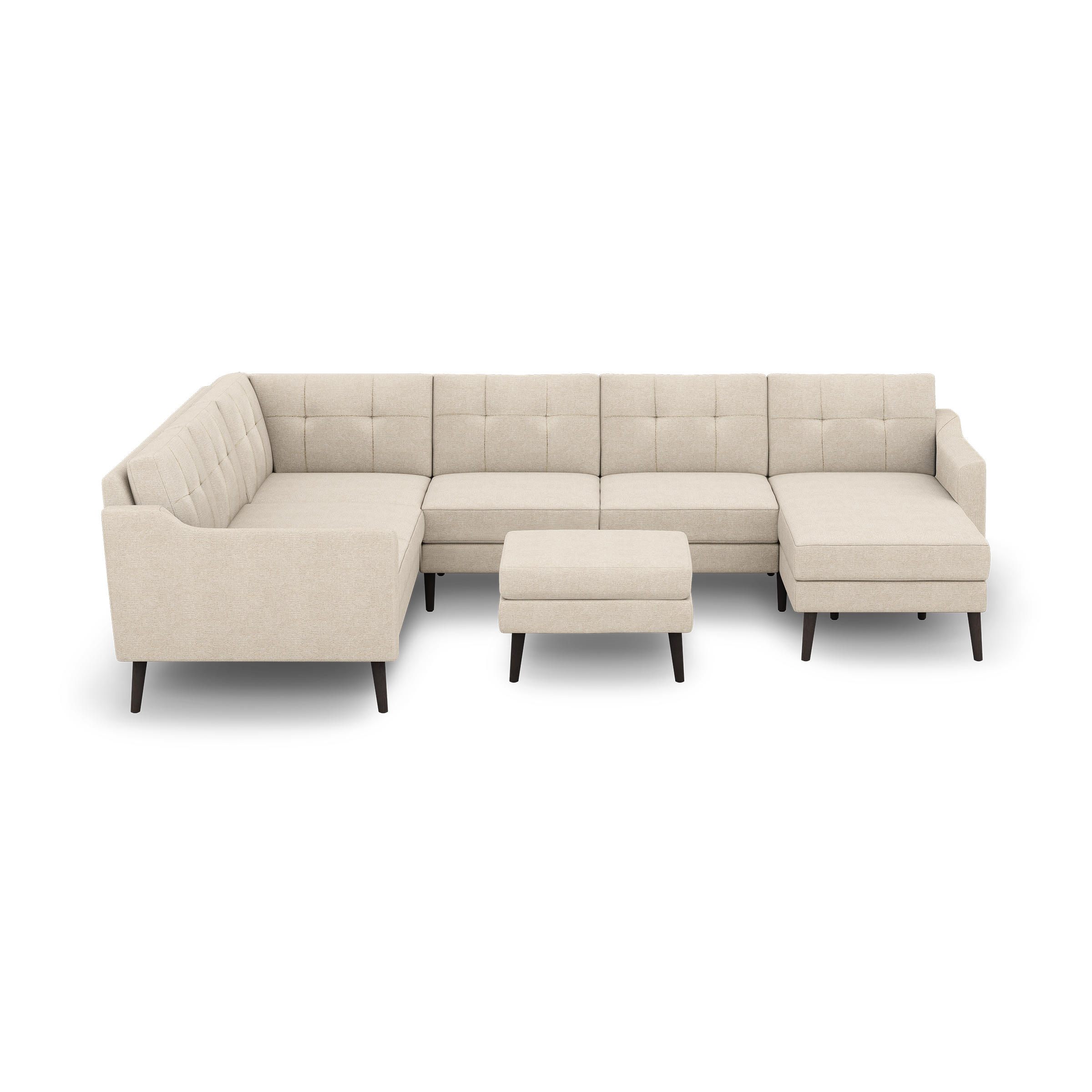 Beige modern sectional sofa with tufted cushions, black tapered legs, including a matching ottoman, isolated on black background.
