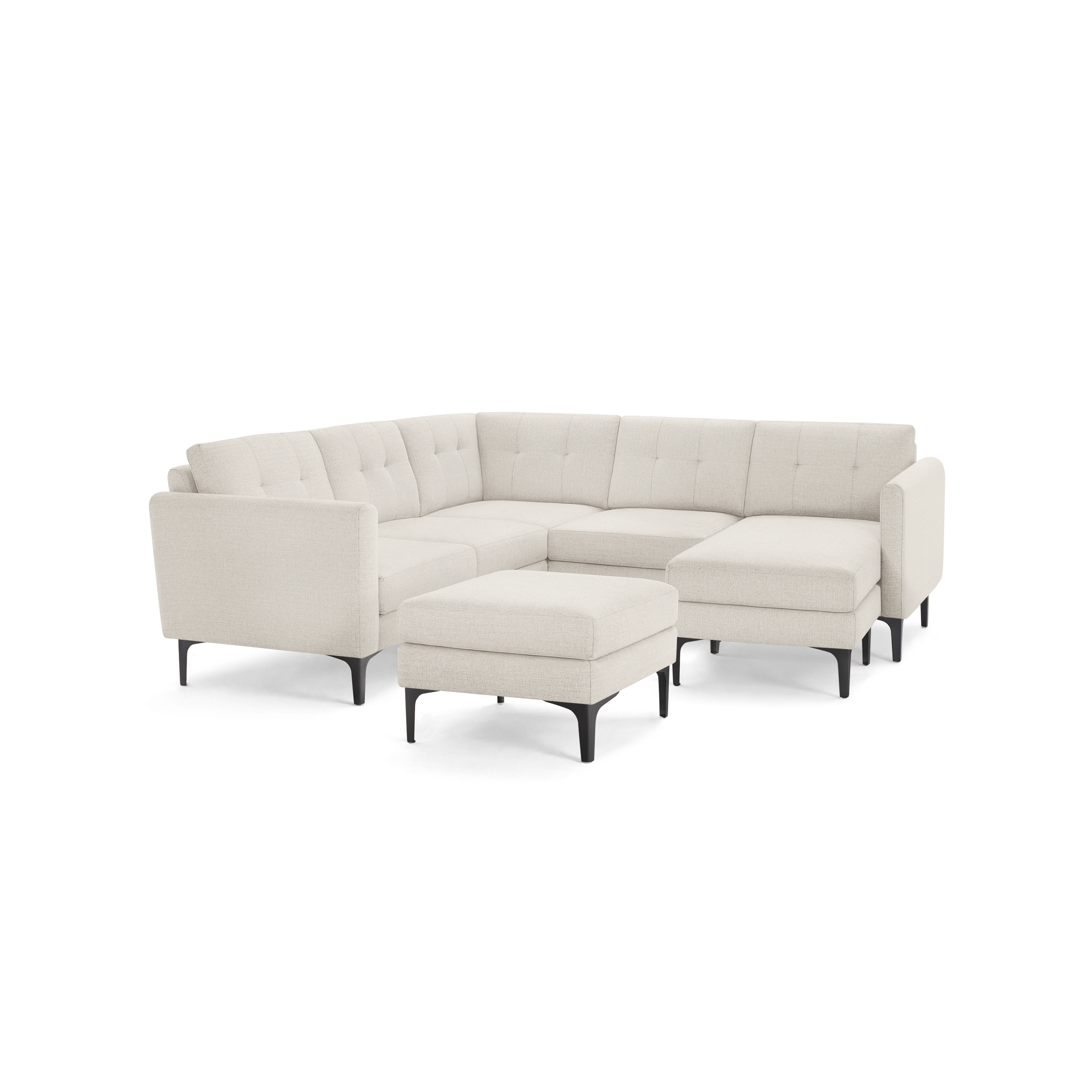 Light beige fabric sectional sofa with tufted back cushions, black metal legs, and a matching ottoman.
