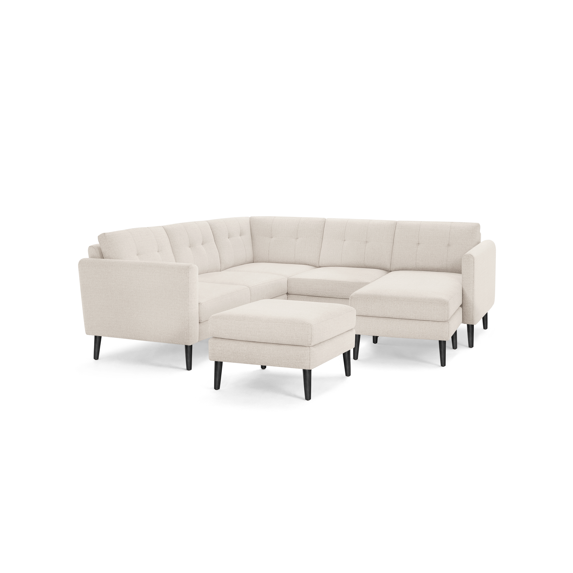 Beige fabric L-shaped sectional sofa with tufted cushions and black tapered wooden legs, including a matching ottoman.
