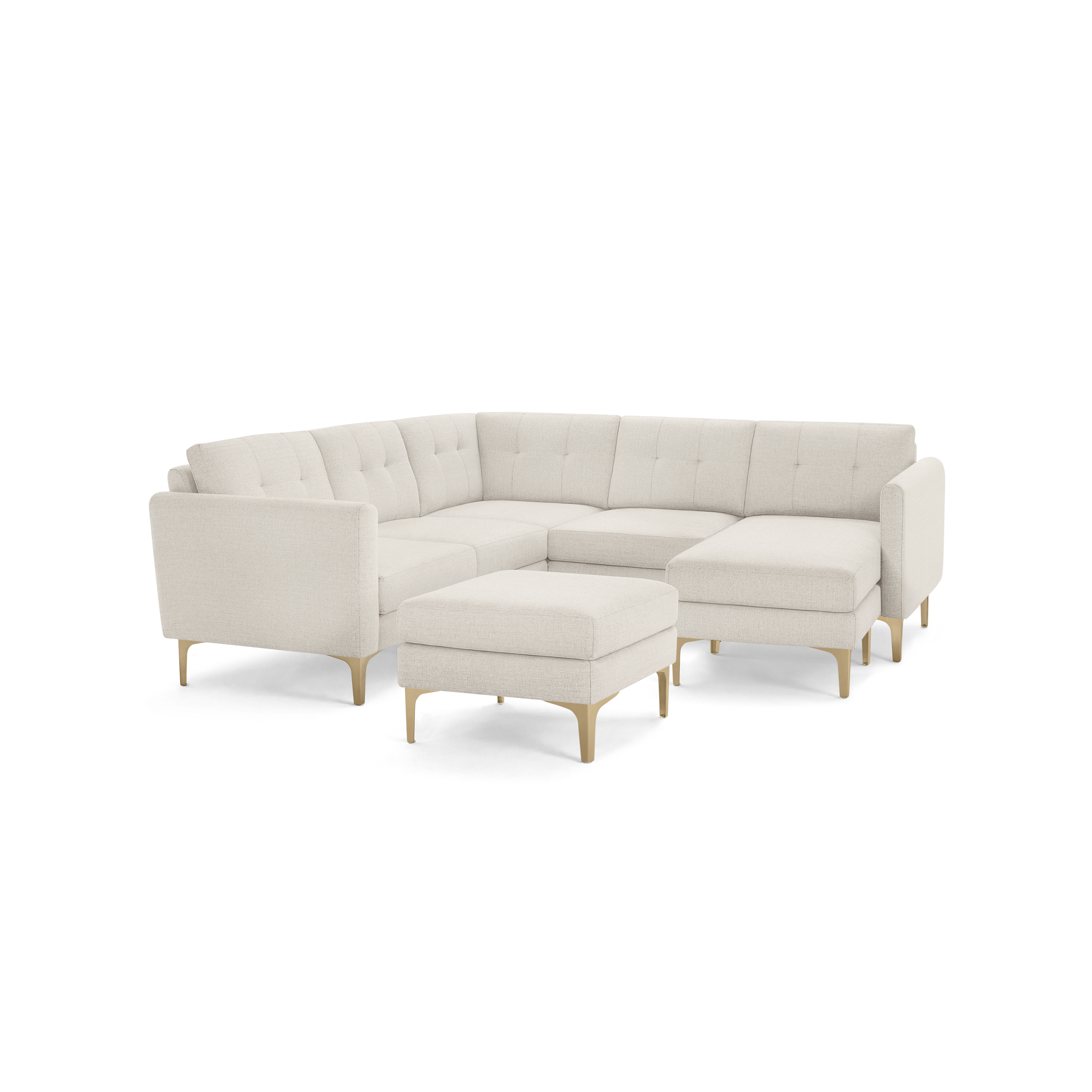 Beige upholstered modern sectional sofa with tufted back cushions, wooden legs, and a matching ottoman on a transparent background.