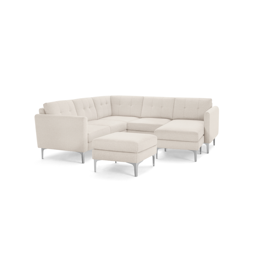 Modern beige fabric sectional sofa with tufted back cushions, metal legs, and matching ottoman, designed for corner seating.