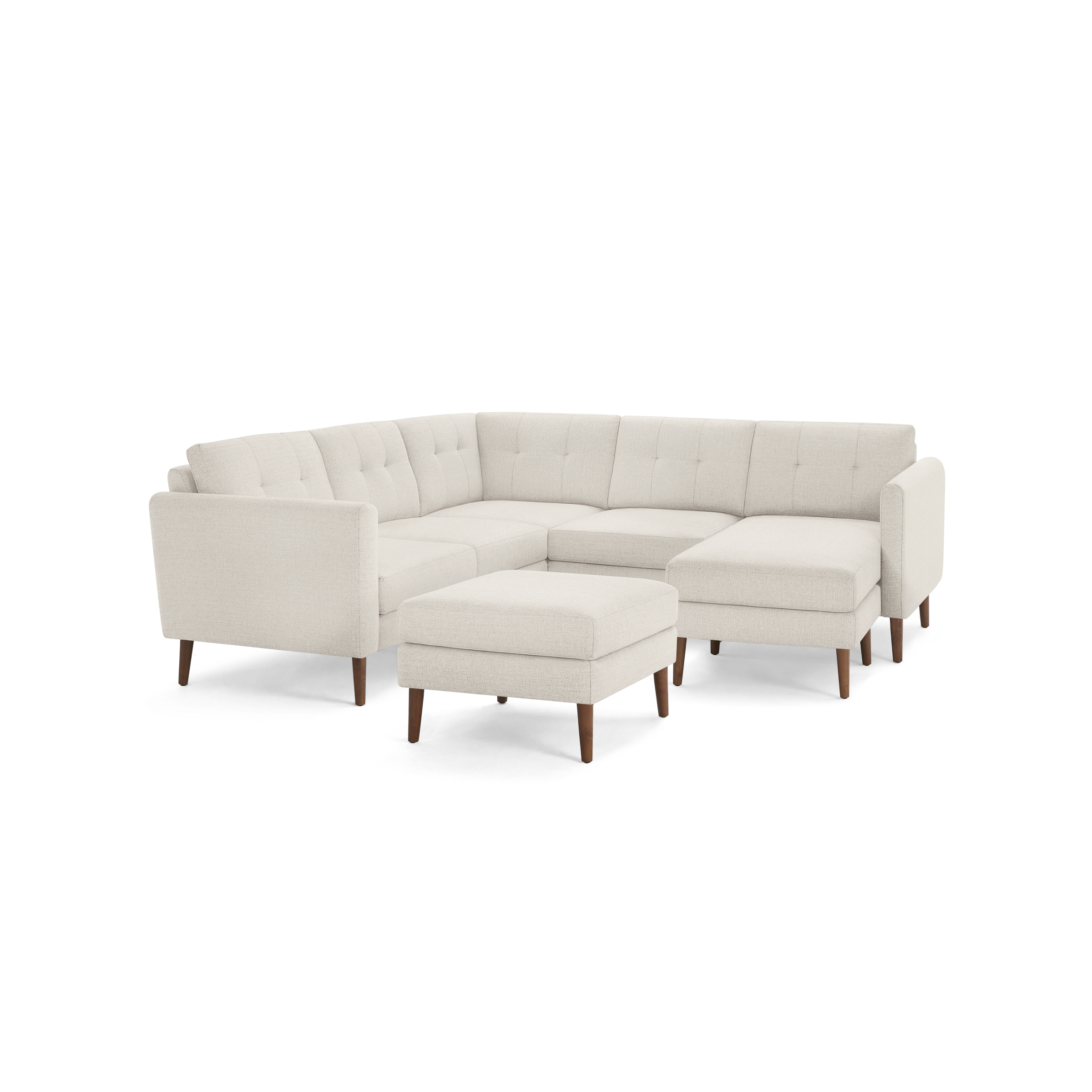 Light beige L-shaped sectional sofa with tufted cushions and wooden tapered legs, including a matching ottoman.