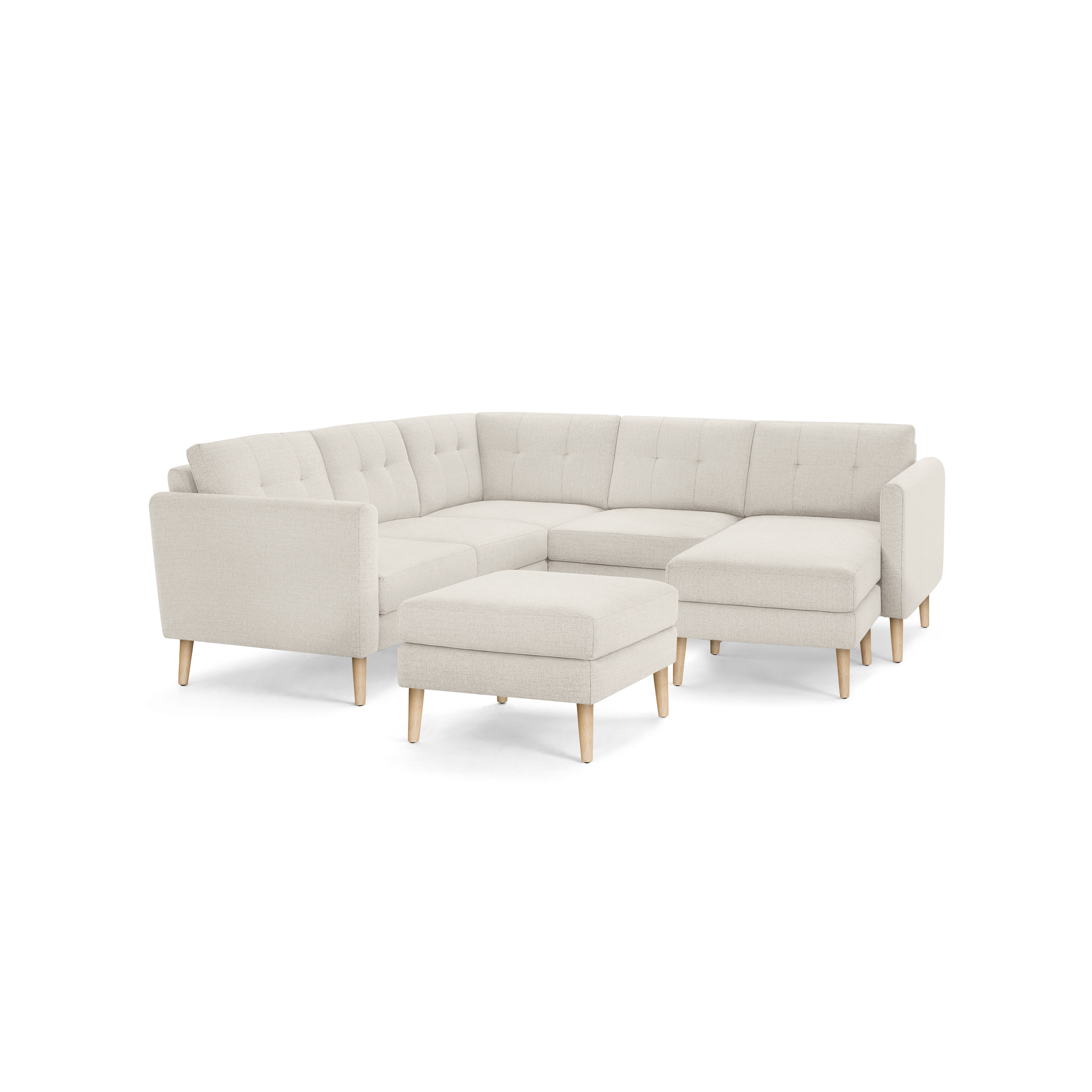 Beige fabric sectional sofa with tufted backrests, wooden tapered legs, and a matching rectangular ottoman against a white background.