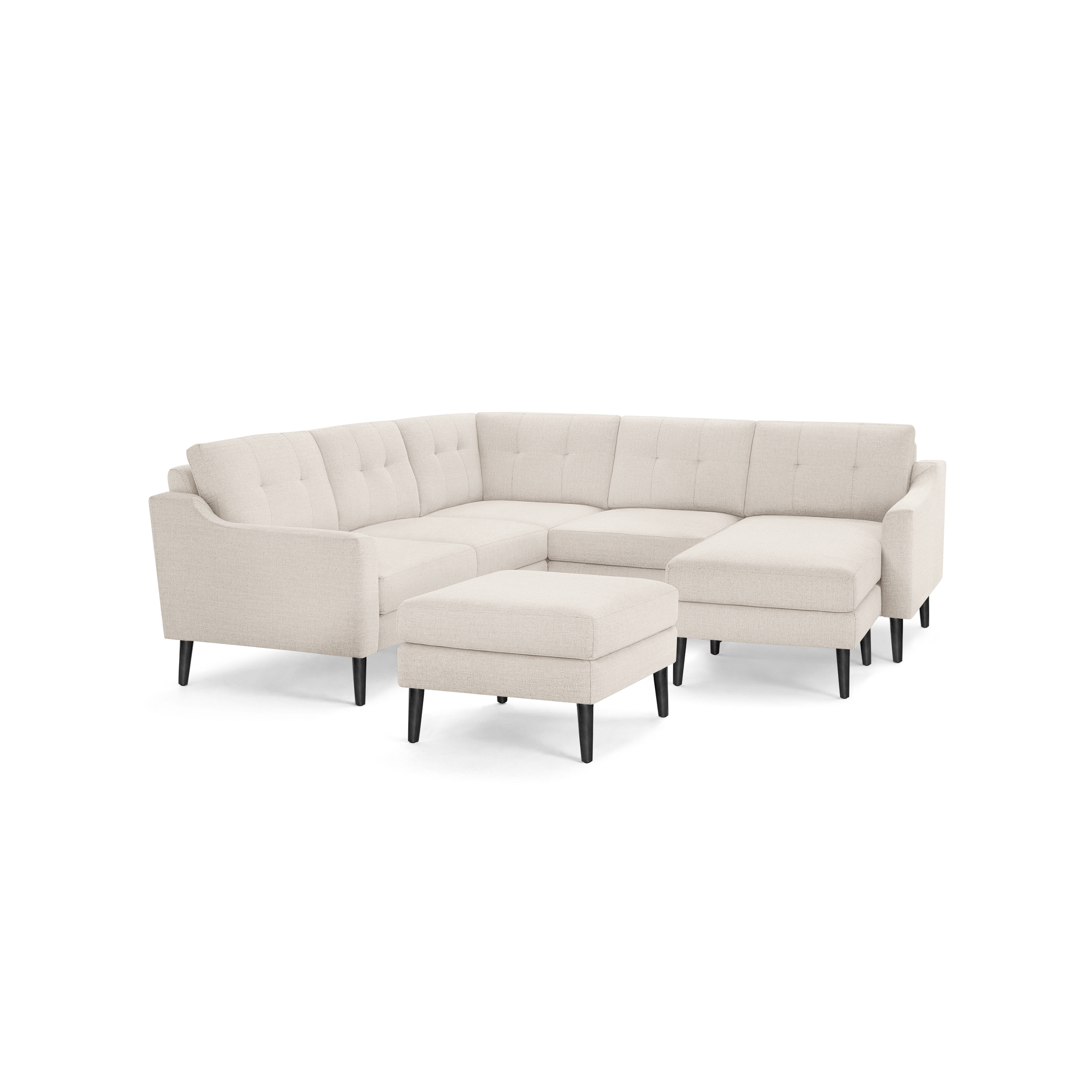 Beige fabric L-shaped sectional sofa with tufted cushions, slim armrests, black wooden legs, and matching ottoman.