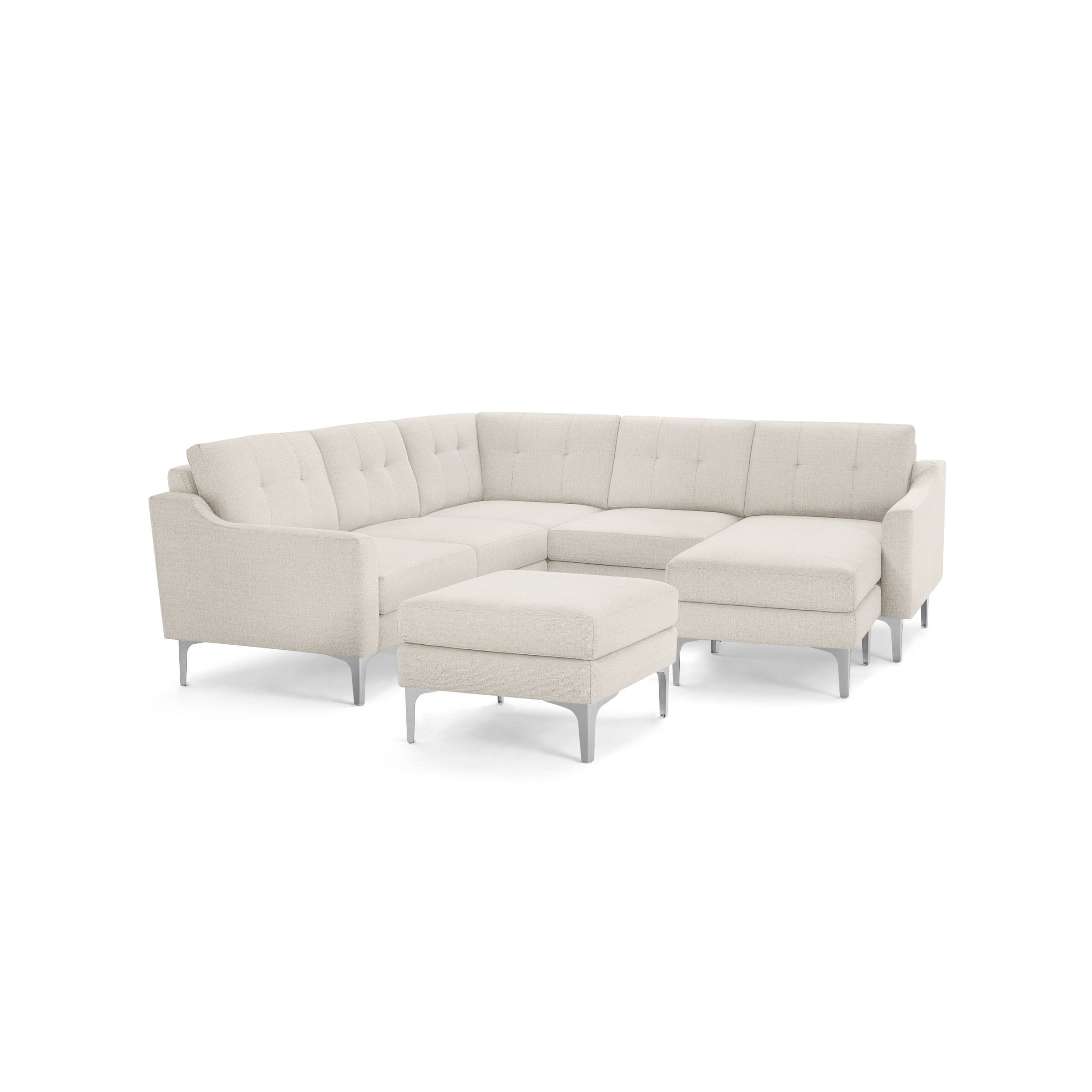Beige upholstered modern sectional sofa with tufted back cushions, metal legs, and matching ottoman on black background.