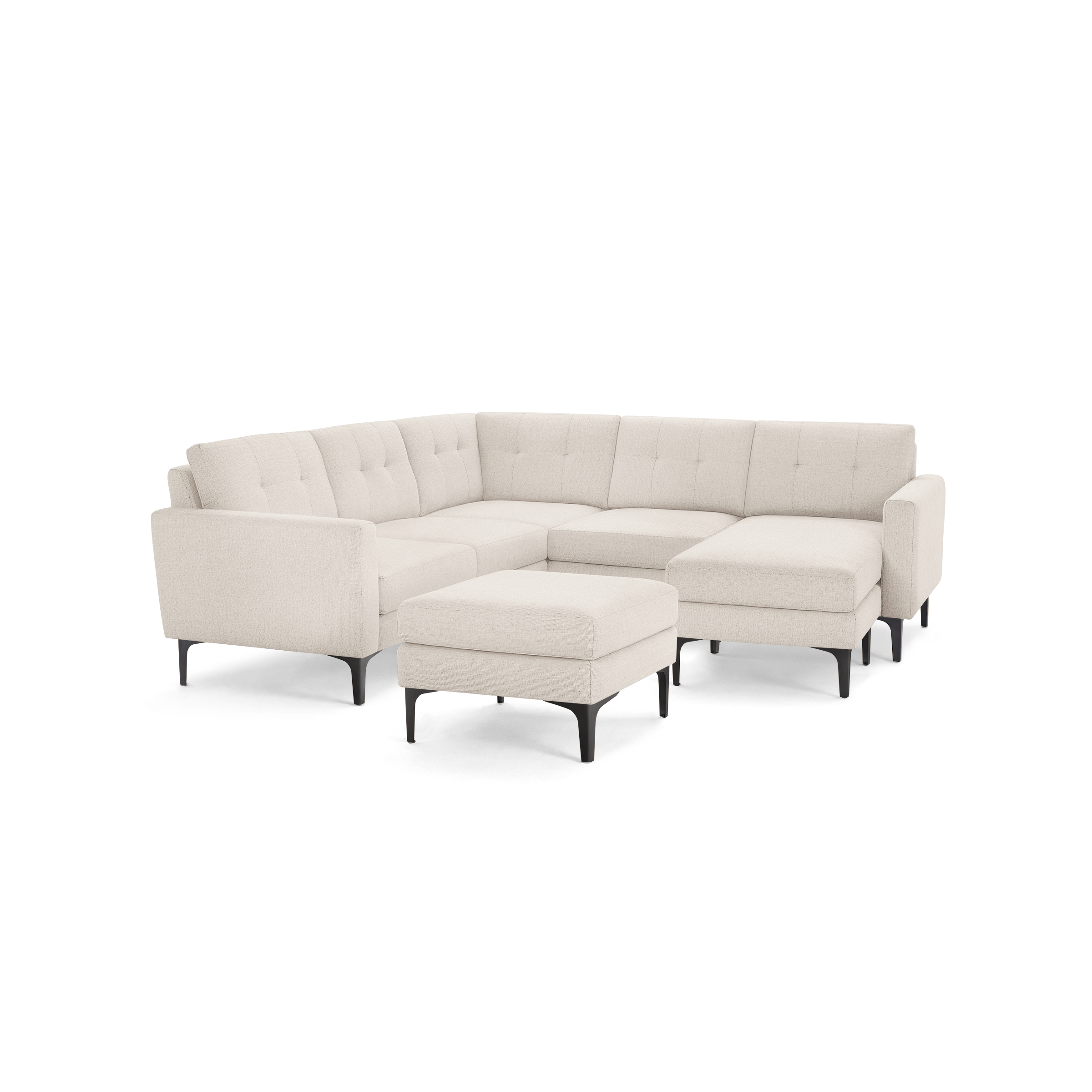 Cream-colored upholstered L-shaped sectional sofa with tufted cushions and matching ottoman, featuring sleek black legs.