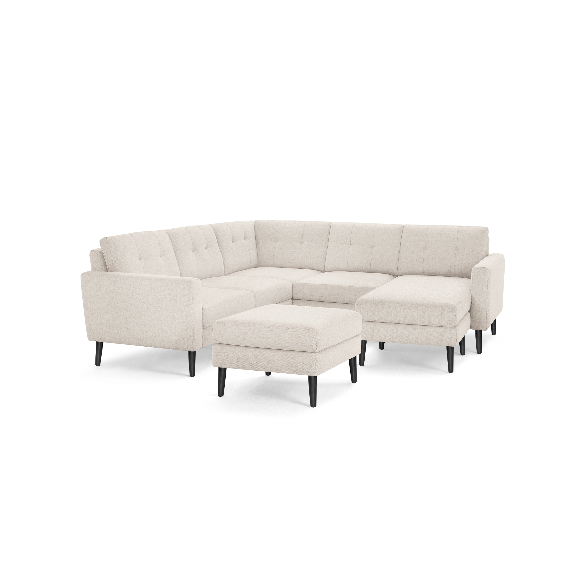 Modern beige fabric sectional sofa with tufted back cushions, right chaise, matching ottoman, and black tapered legs.