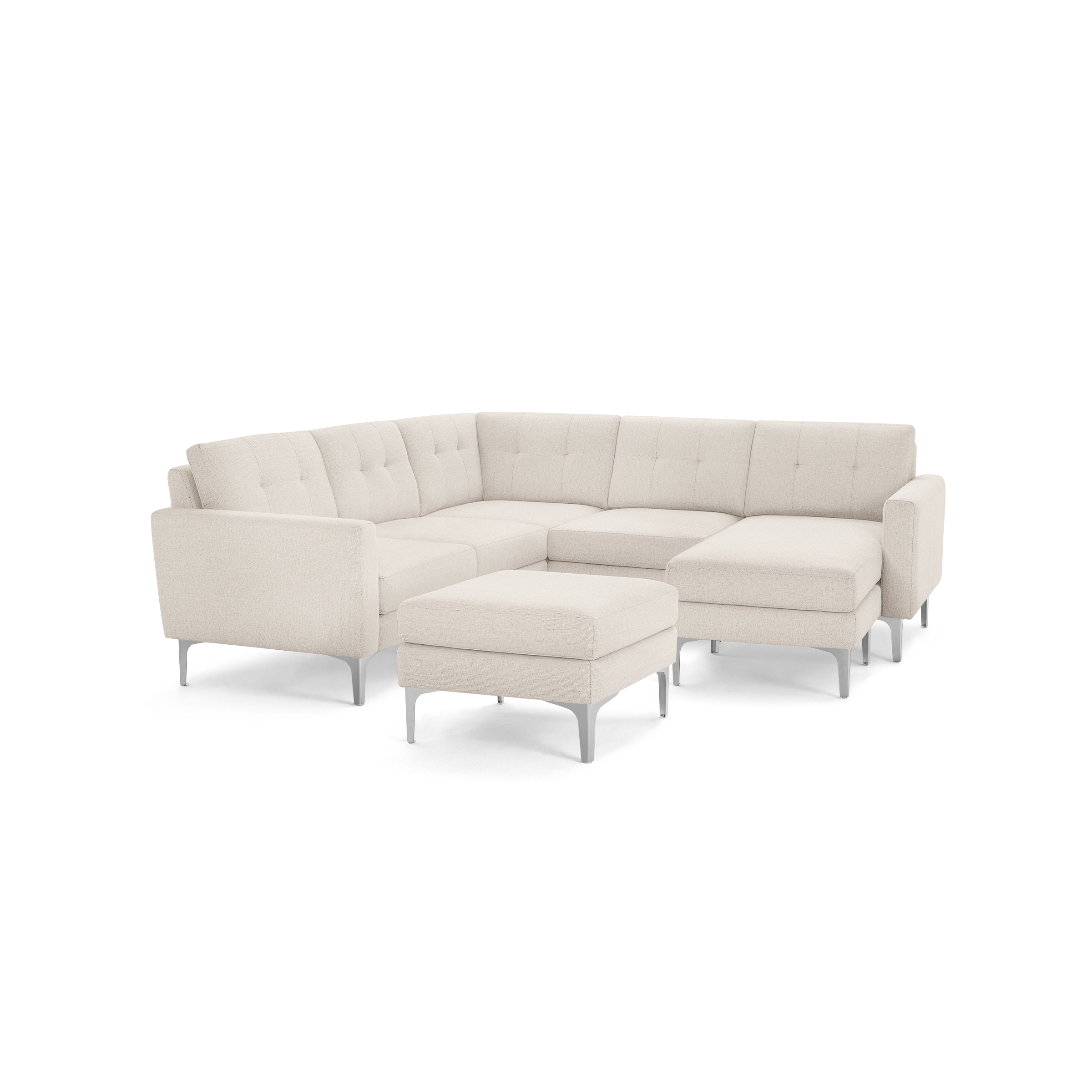 Cream-colored L-shaped sectional sofa with tufted back cushions and matching ottoman, featuring sleek metal legs.