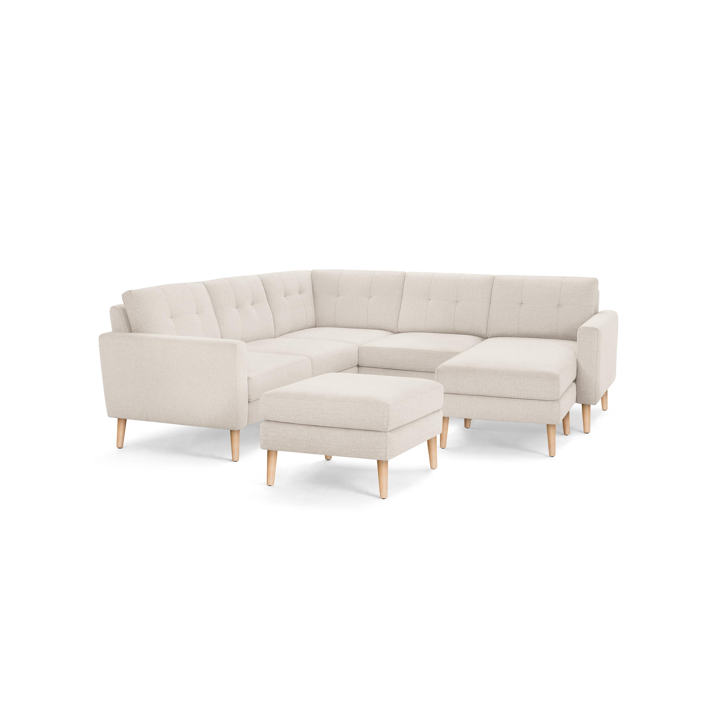 Beige upholstered modern sectional sofa with button-tufted cushions, wooden legs, and a matching ottoman.