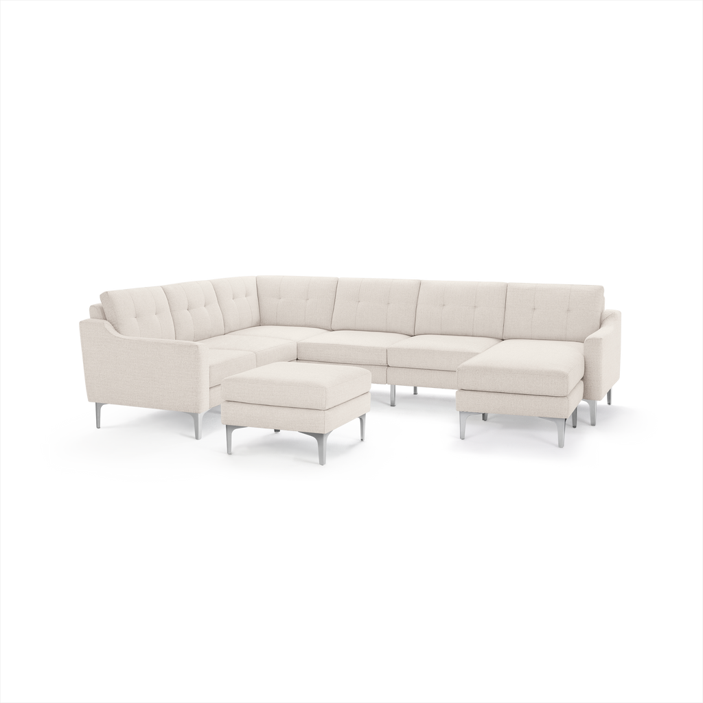 Modern cream-colored sectional sofa with tufted back cushions, metal legs, L-shape design, and matching ottoman.