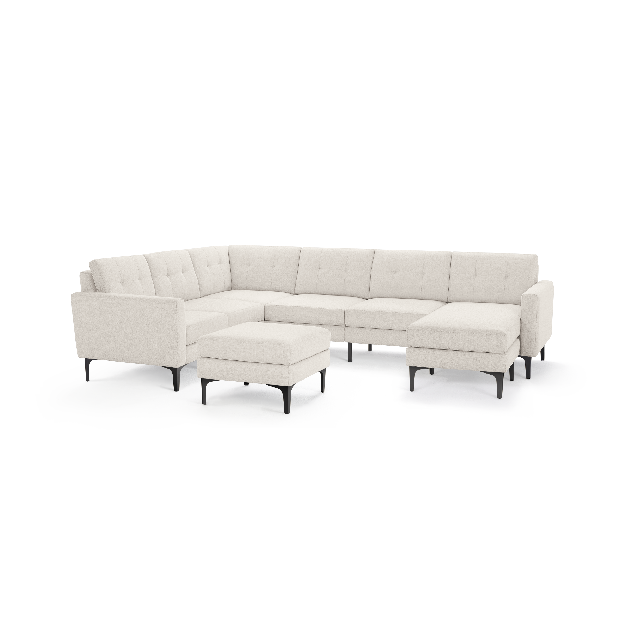 Modern off-white fabric sectional sofa with tufted back cushions, black metal legs, and matching ottoman, designed for spacious living rooms.