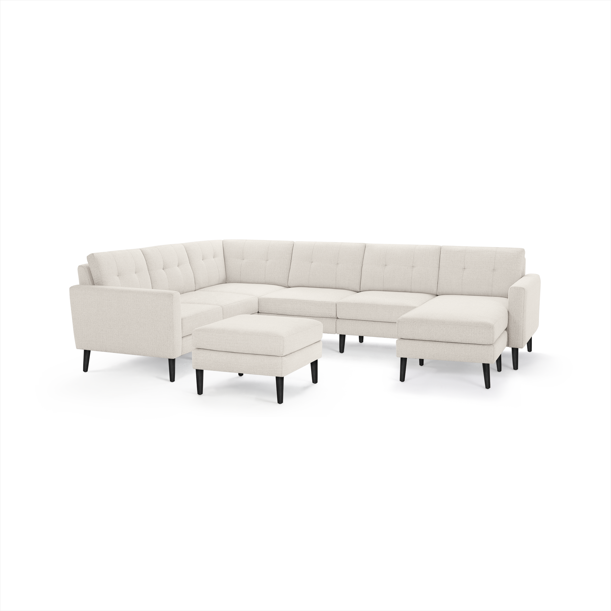 Beige upholstered L-shaped sectional sofa with tufted back cushions, black tapered legs, and matching square ottoman.