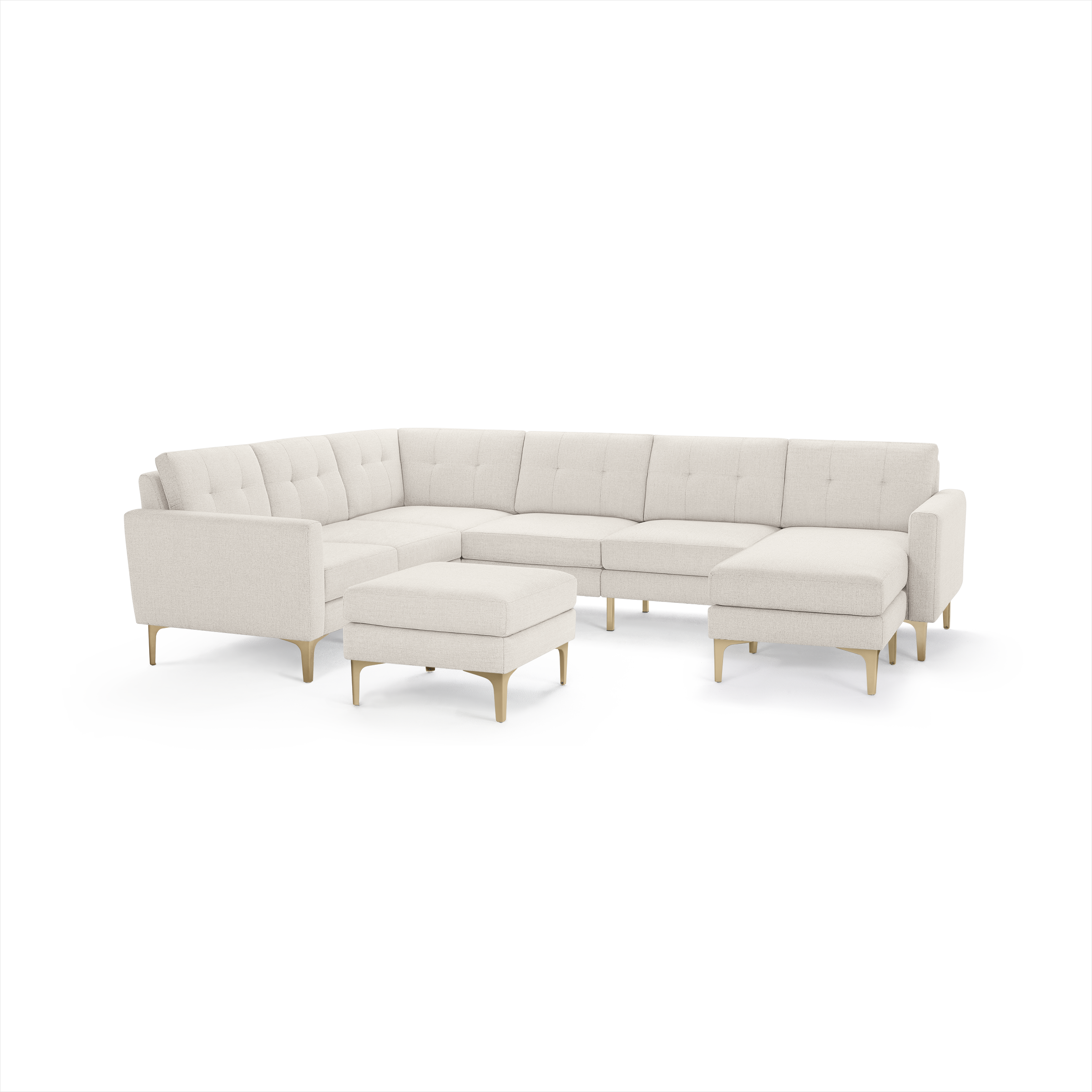 Cream-colored modern sectional sofa with tufted back cushions, wooden legs, and a matching ottoman.