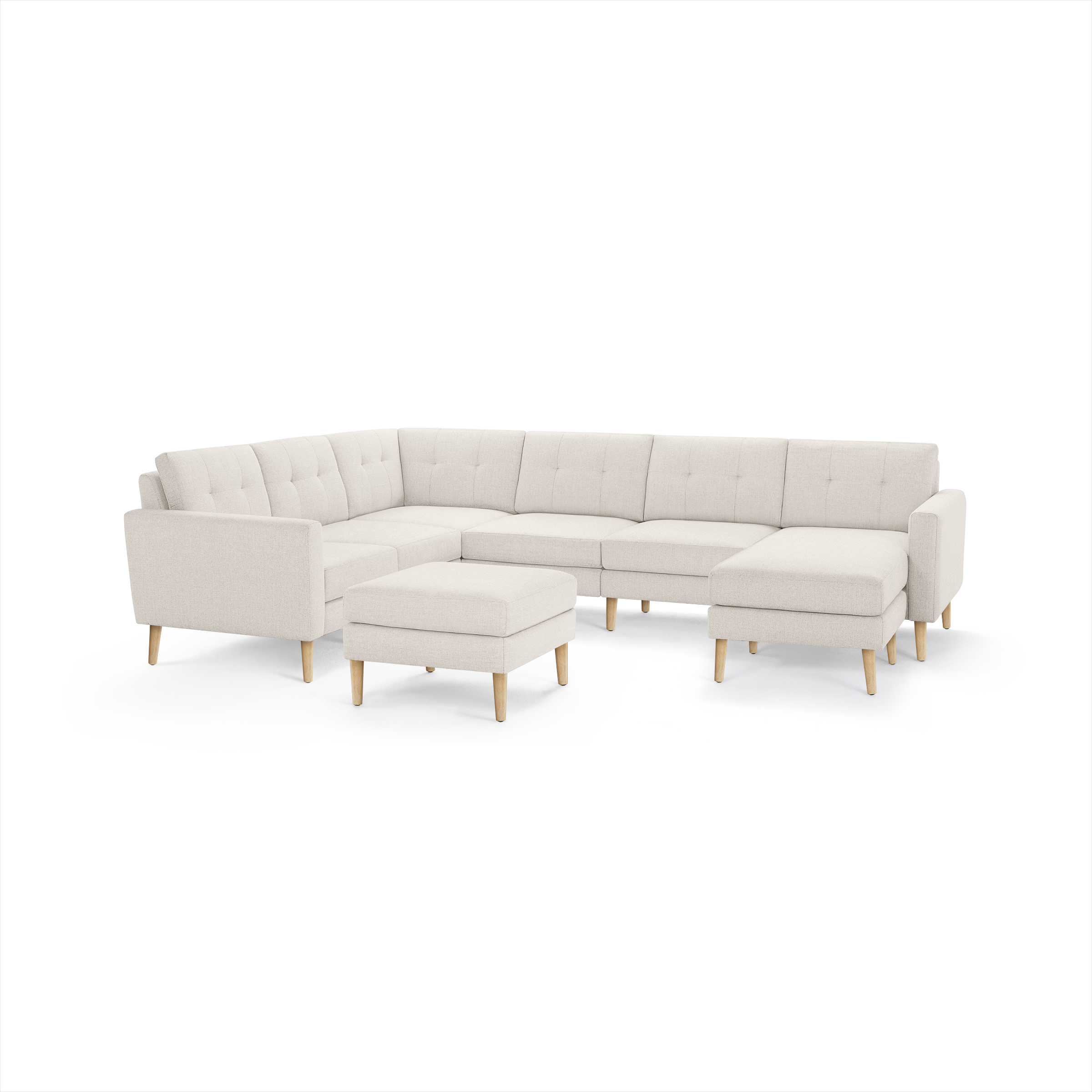 Beige fabric L-shaped sectional sofa with tufted back cushions, wooden legs, and matching ottoman, modern minimalist design.