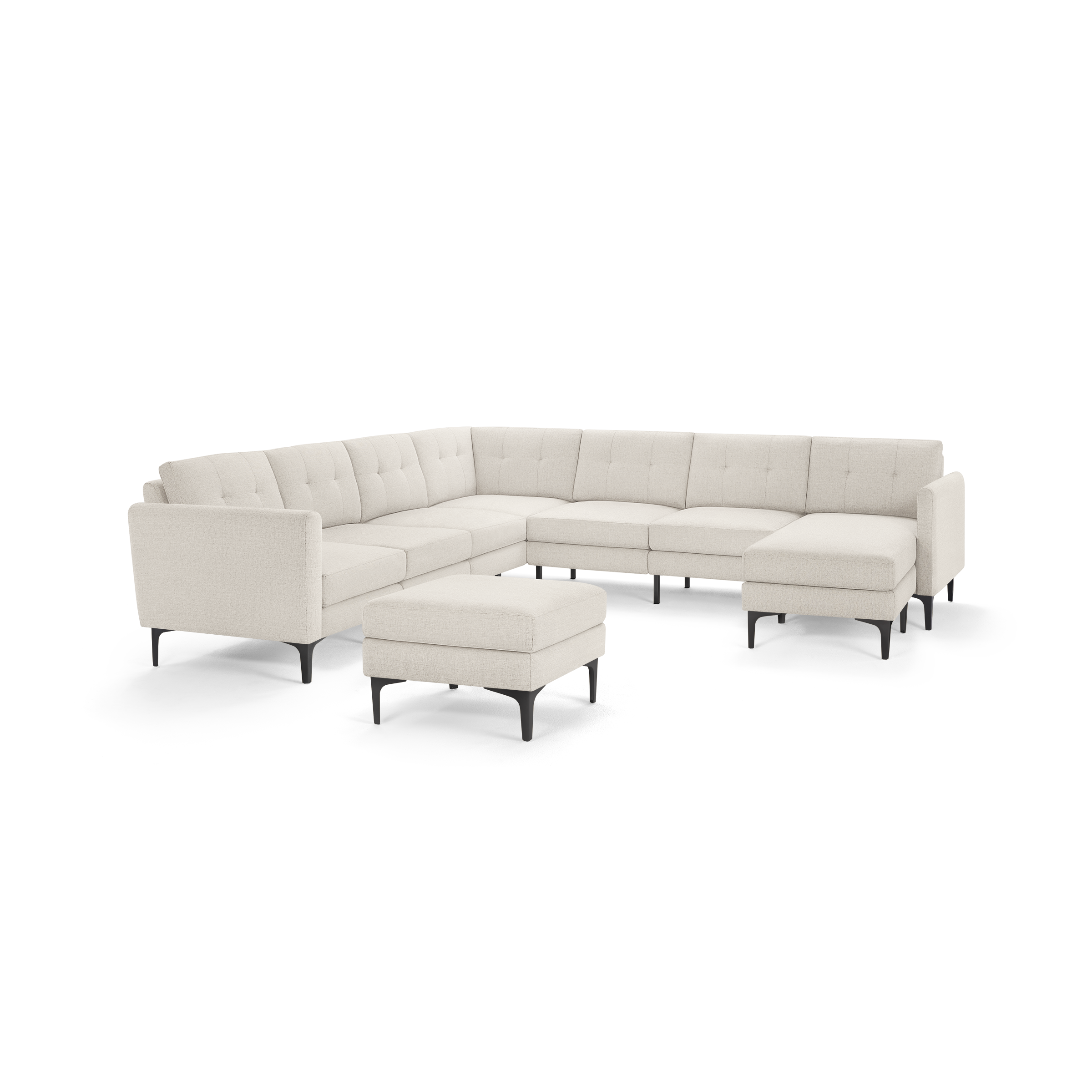 Beige fabric upholstered sectional sofa with tufted backrest and black metal legs, including a matching ottoman.