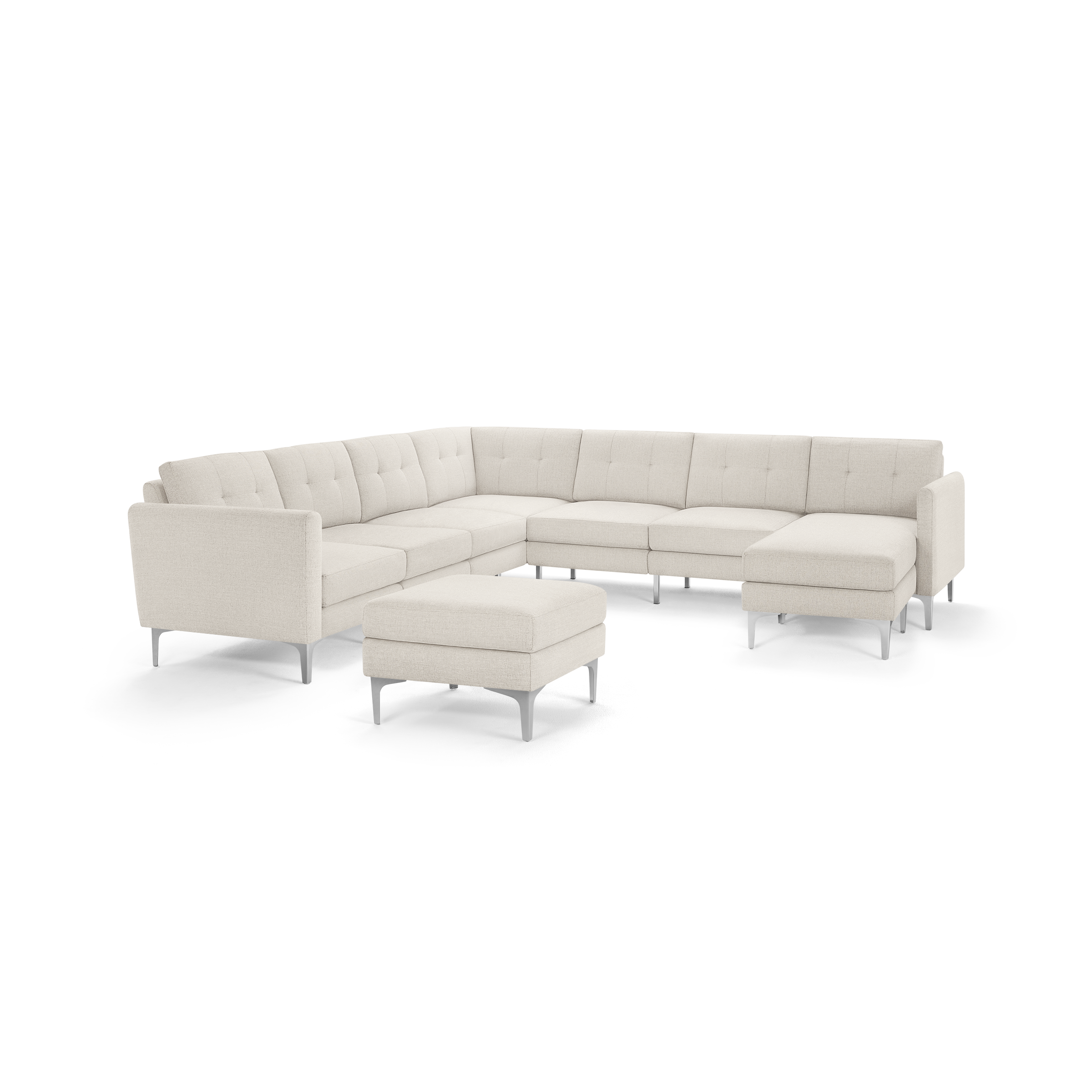 Light beige L-shaped sectional sofa with tufted cushions and matching ottoman on slim metal legs, modern and minimalistic design.