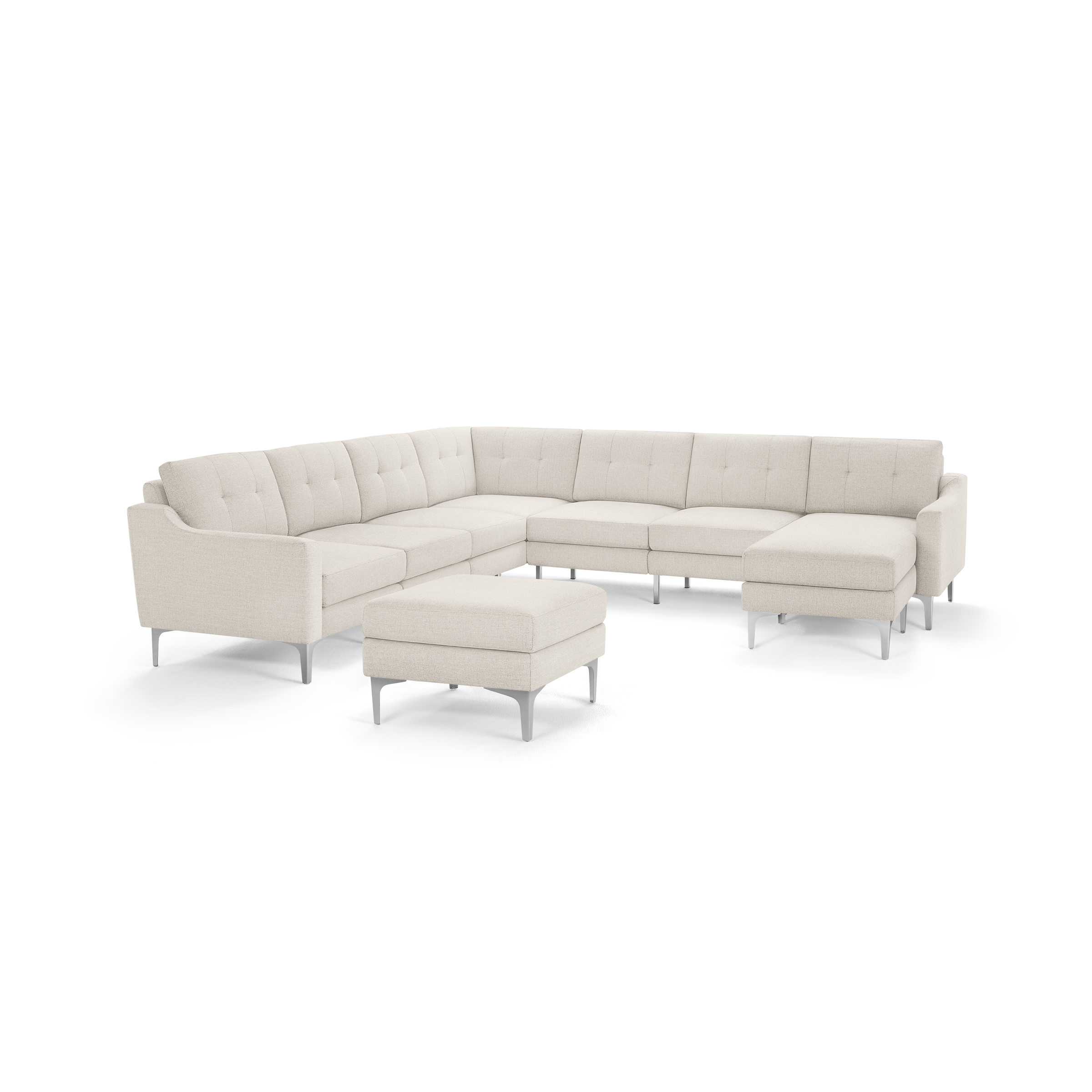 Modern beige L-shaped sectional sofa with tufted cushions, metal legs, and matching ottoman, designed for spacious living rooms.