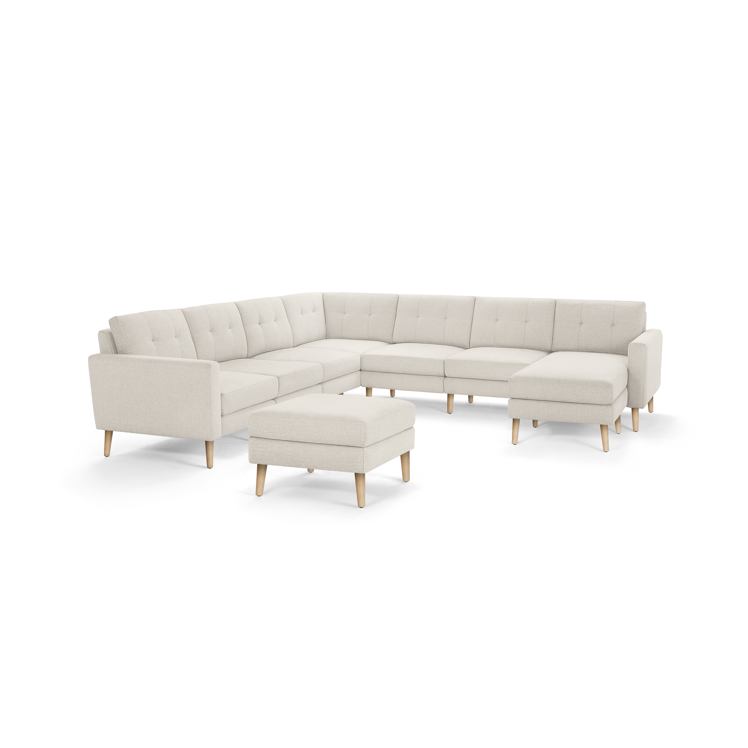 Beige fabric sectional sofa with tufted back cushions, wooden legs, and a matching ottoman, modern and minimalist design.