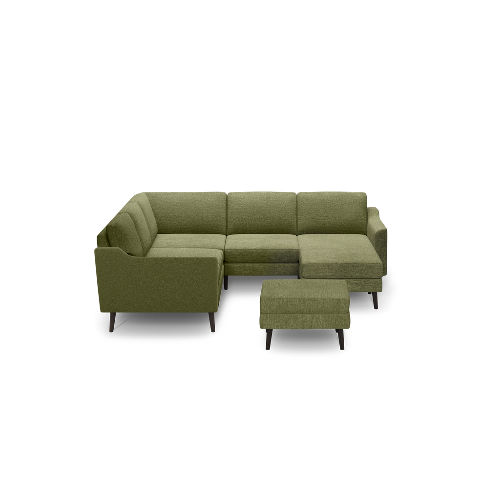 Olive green L-shaped sectional sofa with tufted cushions and matching ottoman, featuring dark tapered wooden legs.