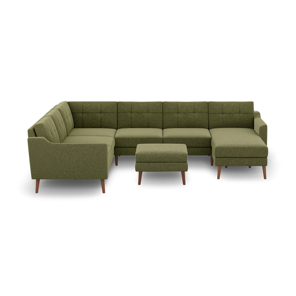 Large olive green mid-century modern sectional sofa with tufted cushions and matching ottoman on wooden legs.
